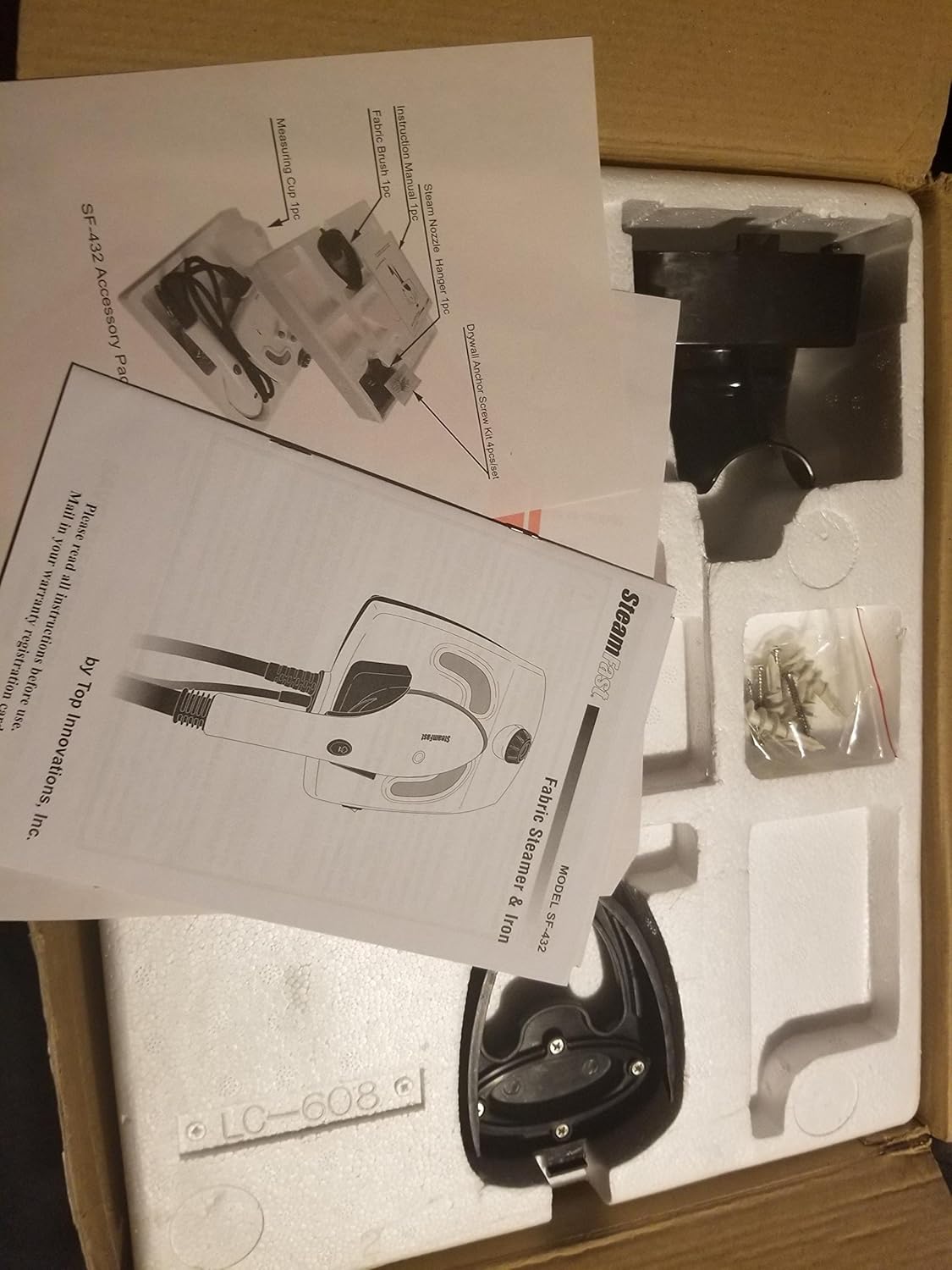 Contents of the SteamFast SF-432 box, including the steamer, manual, and accessories