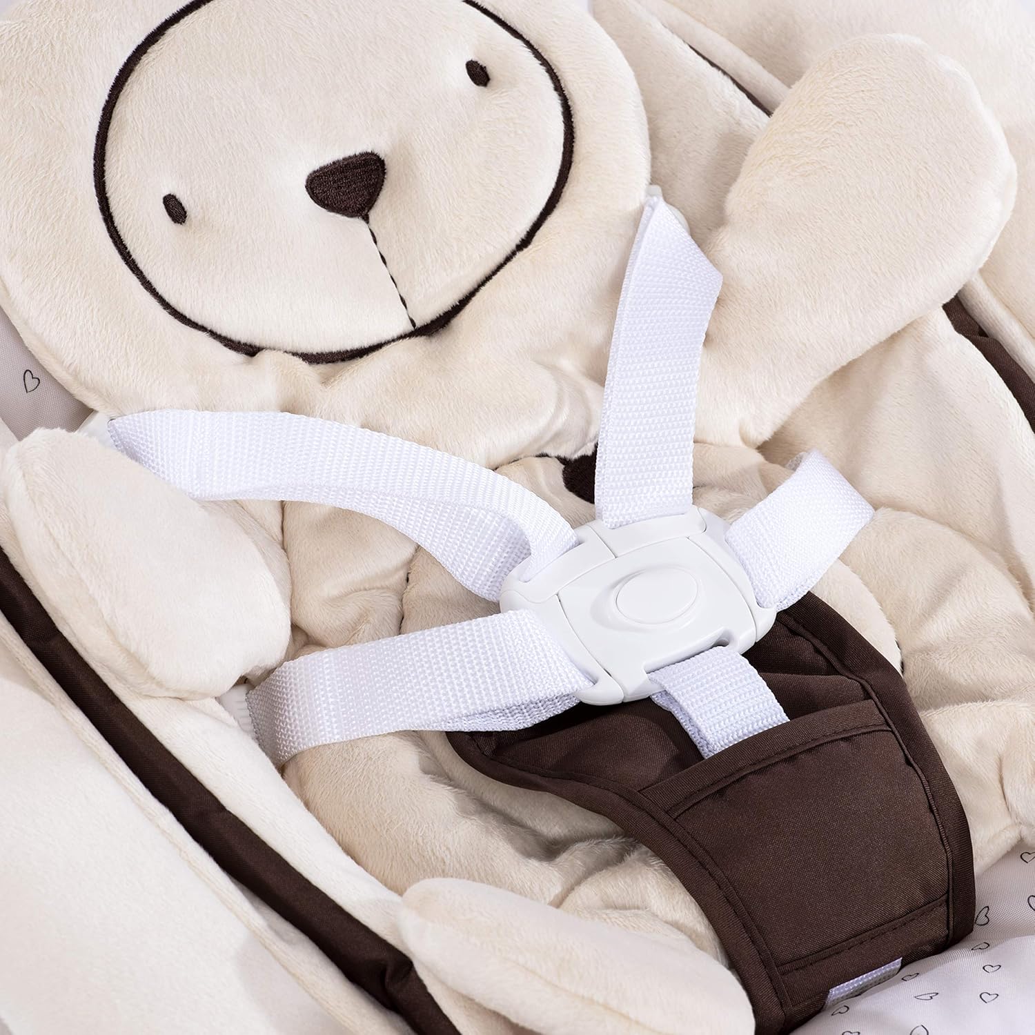 Close-up of the 5-point harness system and plush bear insert in the Hauck Alpha Bouncer.