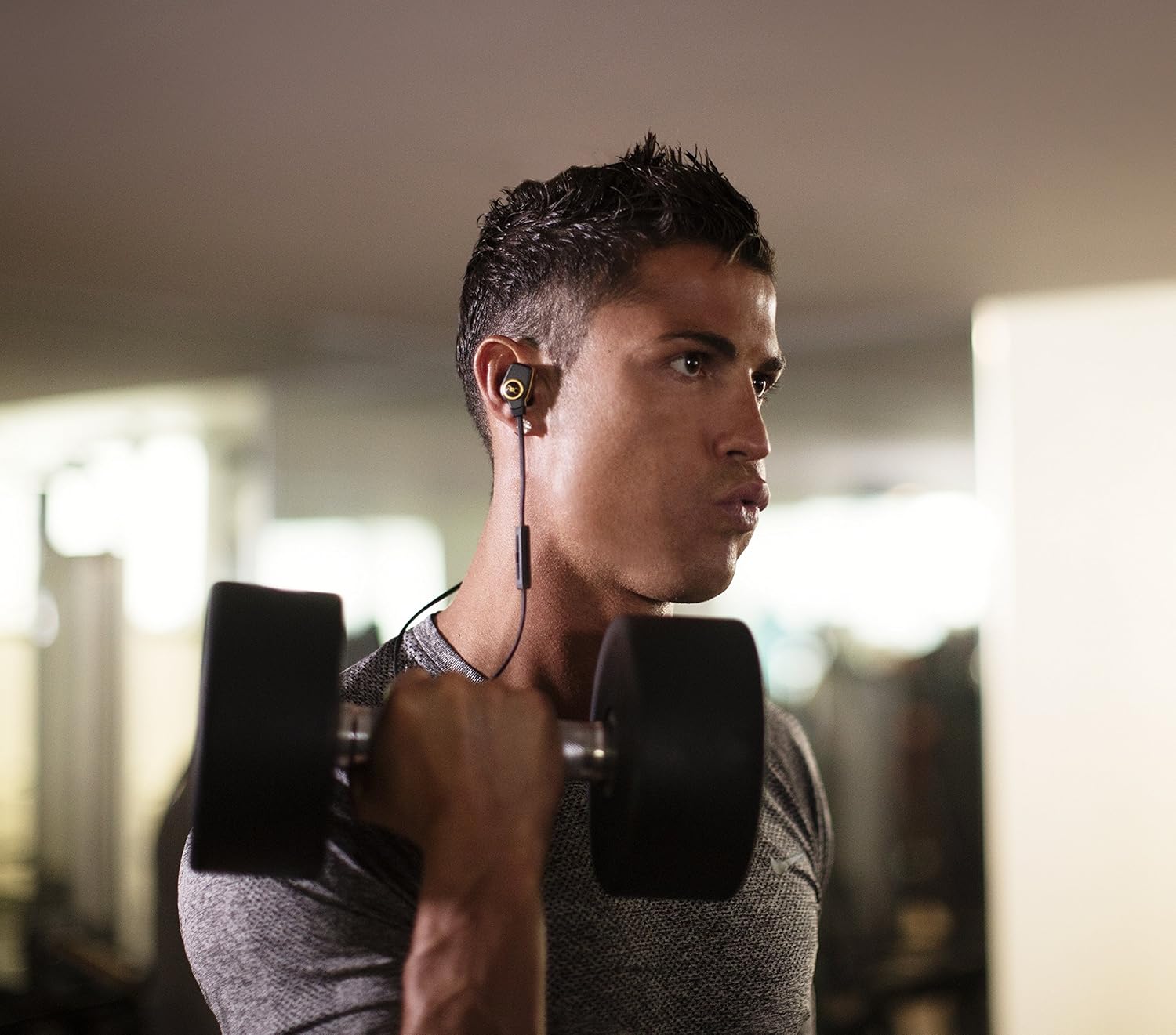 Person wearing Monster ROC Sport SuperSlim headphones during a workout