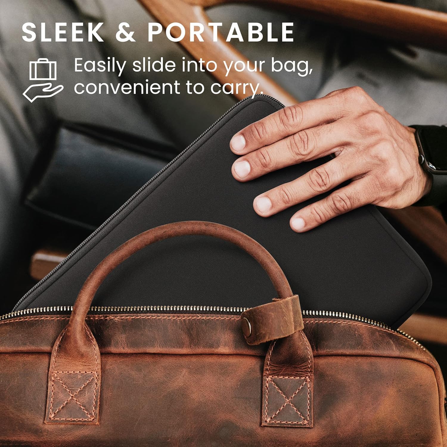 A hand sliding the tablet pouch into a brown leather bag