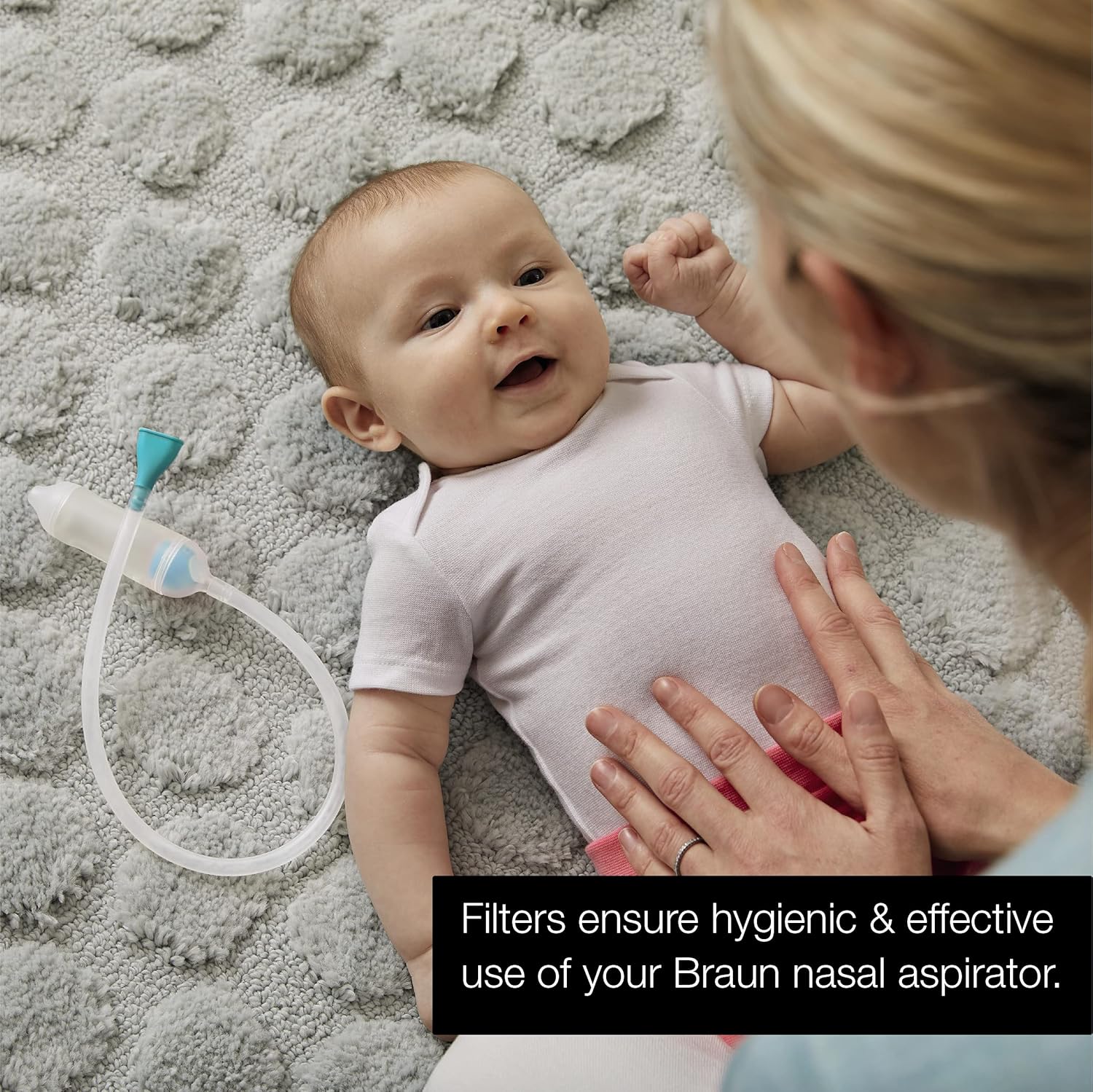 Baby with Braun nasal aspirator, showing filter function
