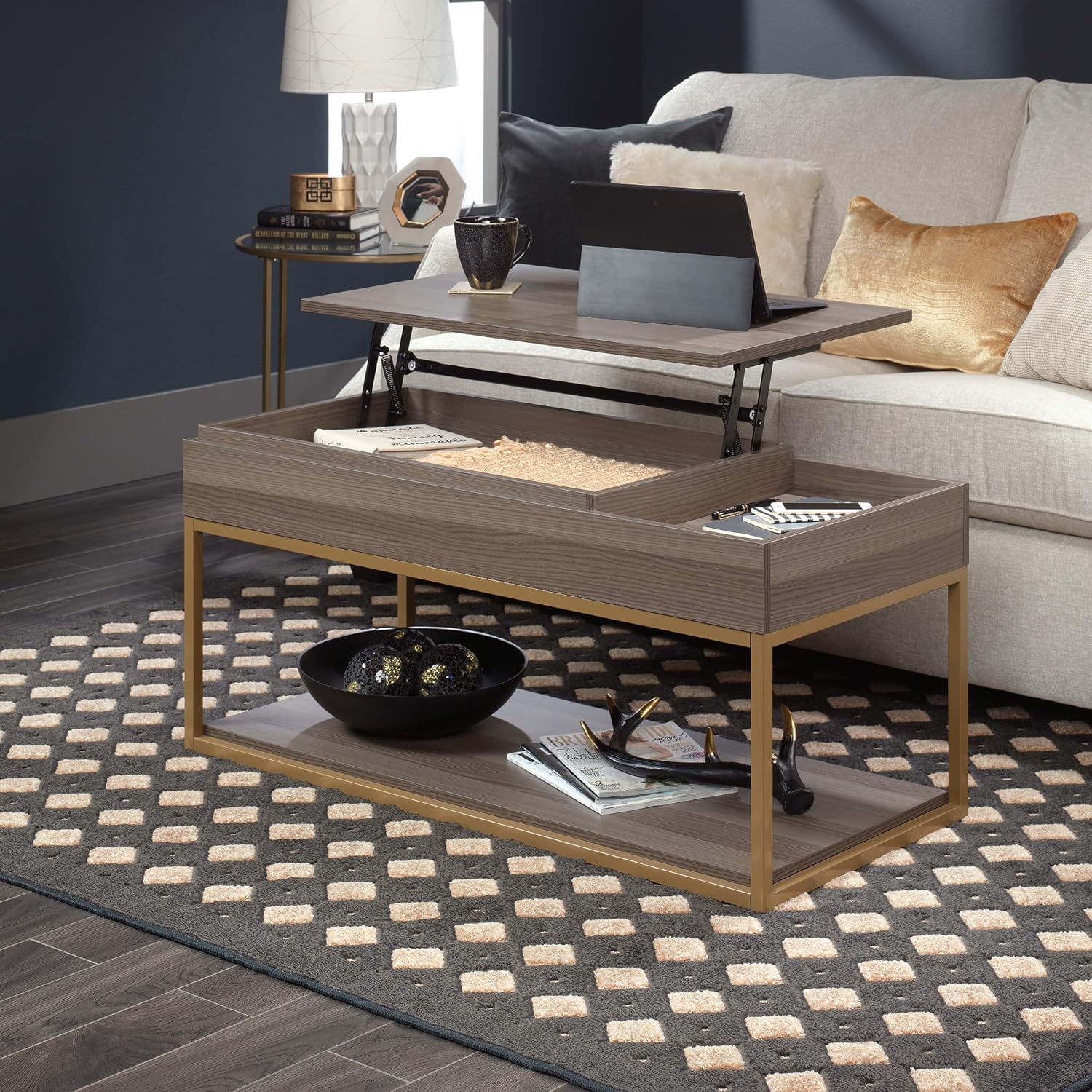 Sauder International Lux Lift-top Coffee Table with top lifted, showing a laptop and mug
