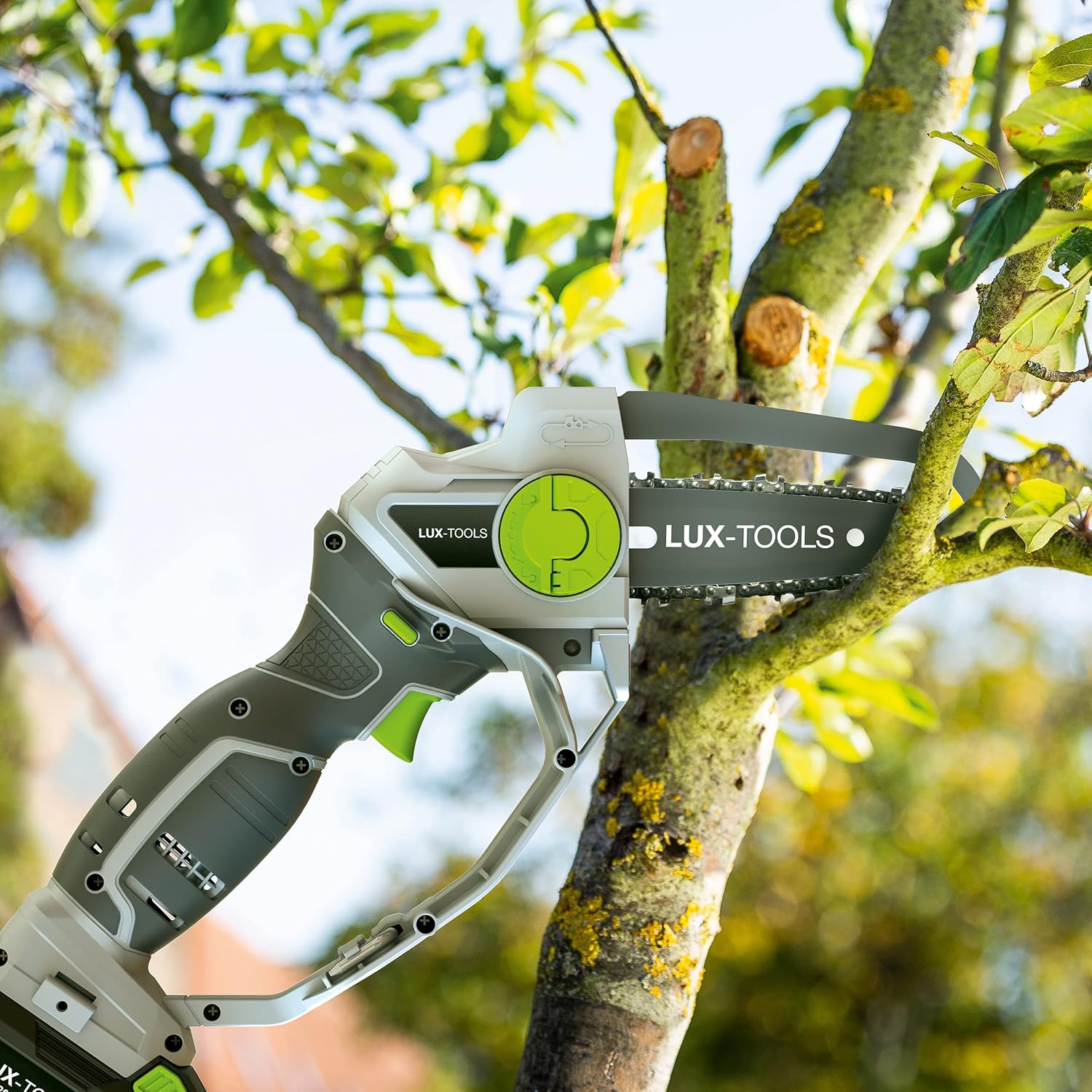 LUX-TOOLS cordless pruning saw cutting a branch on a tree, showing the saw's maneuverability.