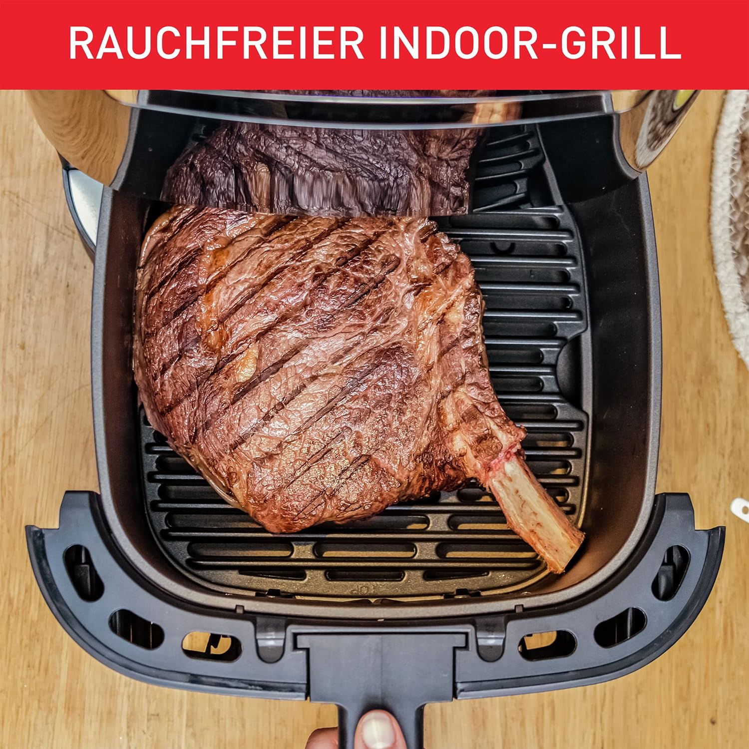 Large steak cooking on the grill plate inside the air fryer