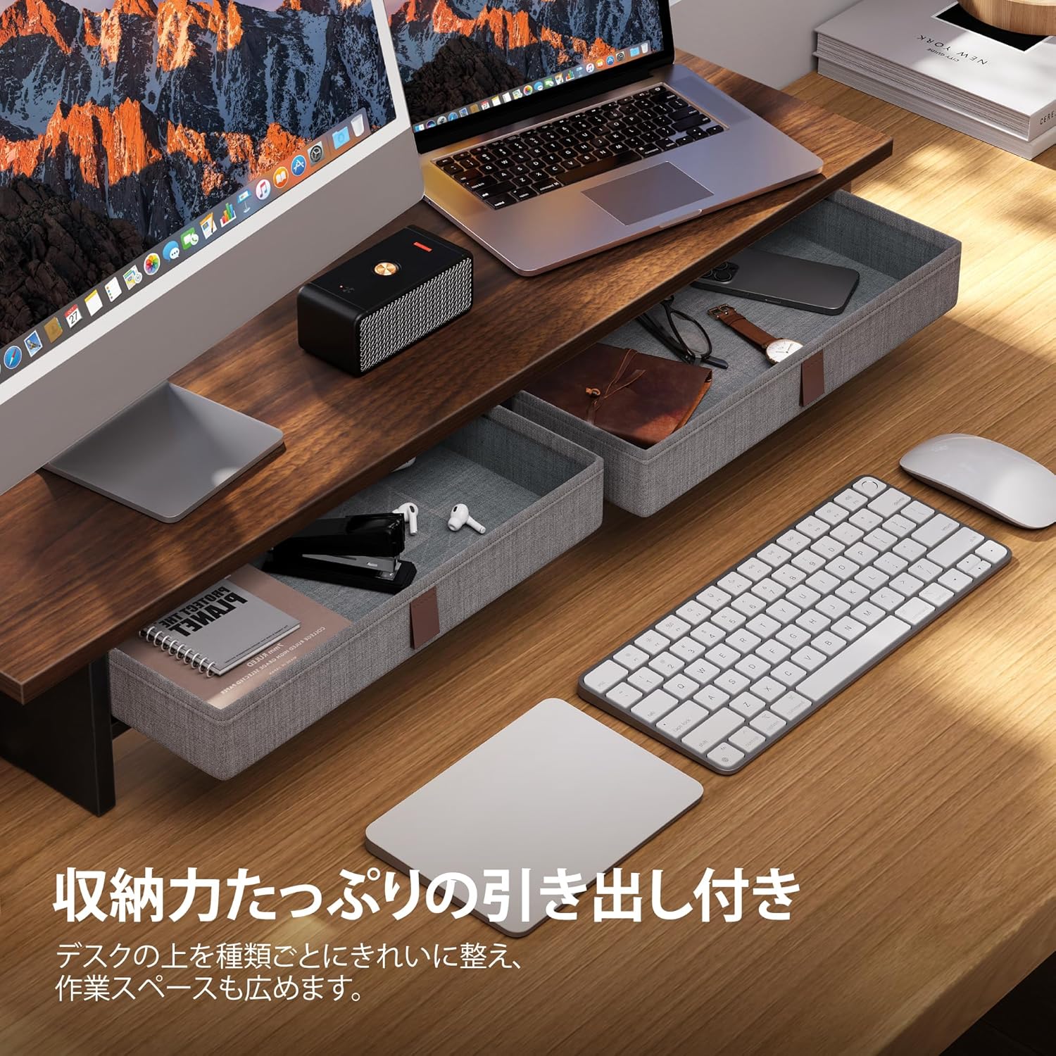 Open drawers of the Fenge monitor stand, showing organized office supplies.