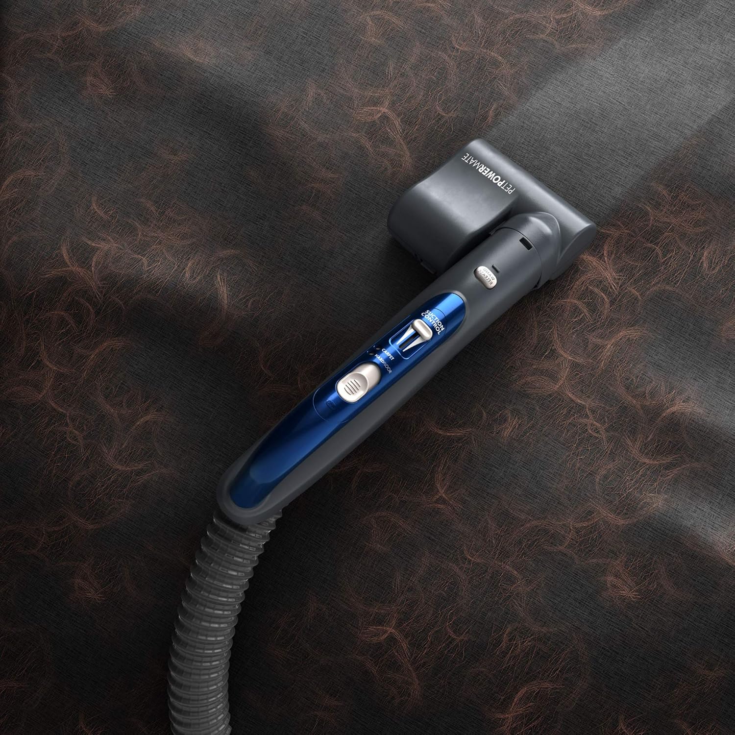 Close-up of the Pet PowerMate attachment on a dark, furry surface