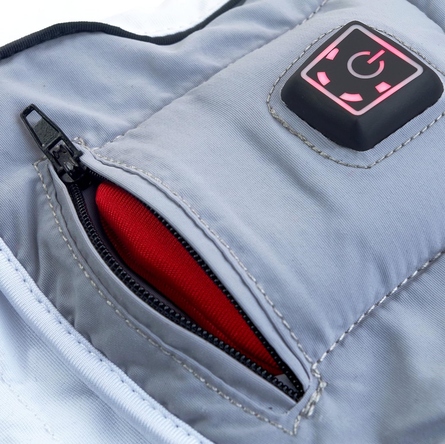 Close-up of a Glovii heated glove with the battery compartment zipper open, showing the red battery pack partially inserted.