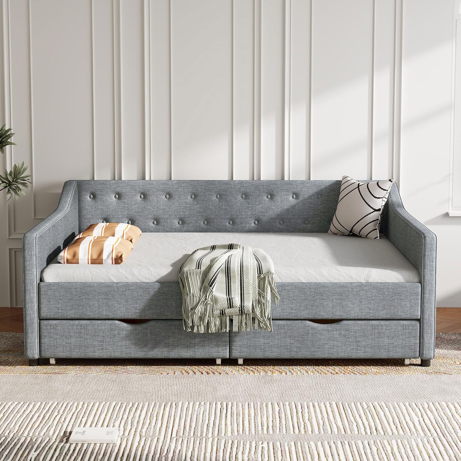 FAVSH Daybed configured as a sofa with pillows and blanket