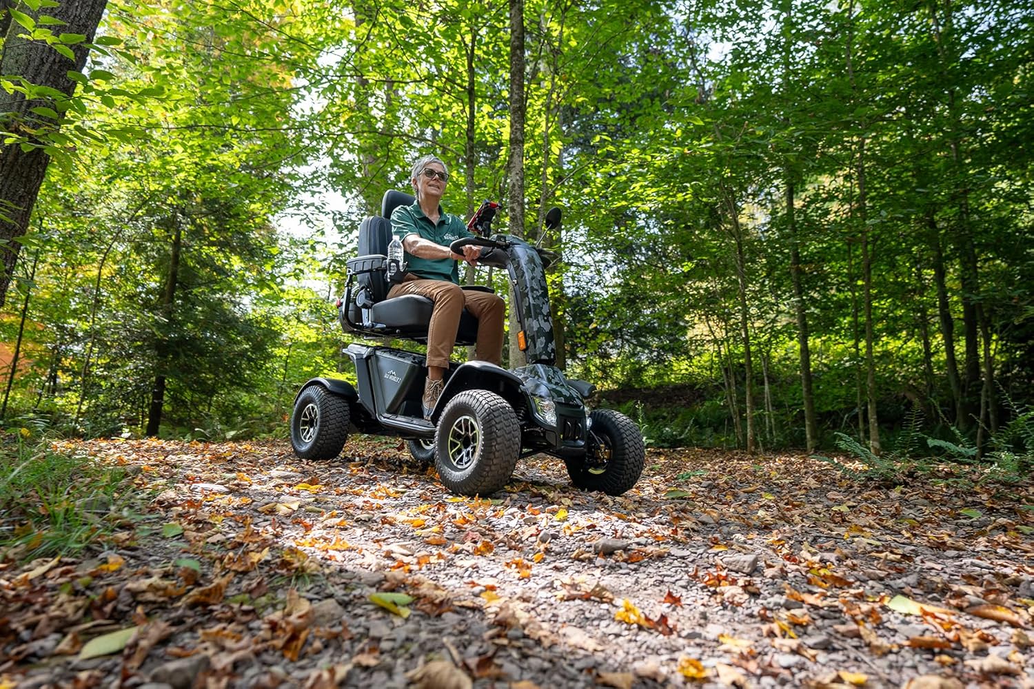 Person riding a Pride Baja Wrangler 2 on a wooded path