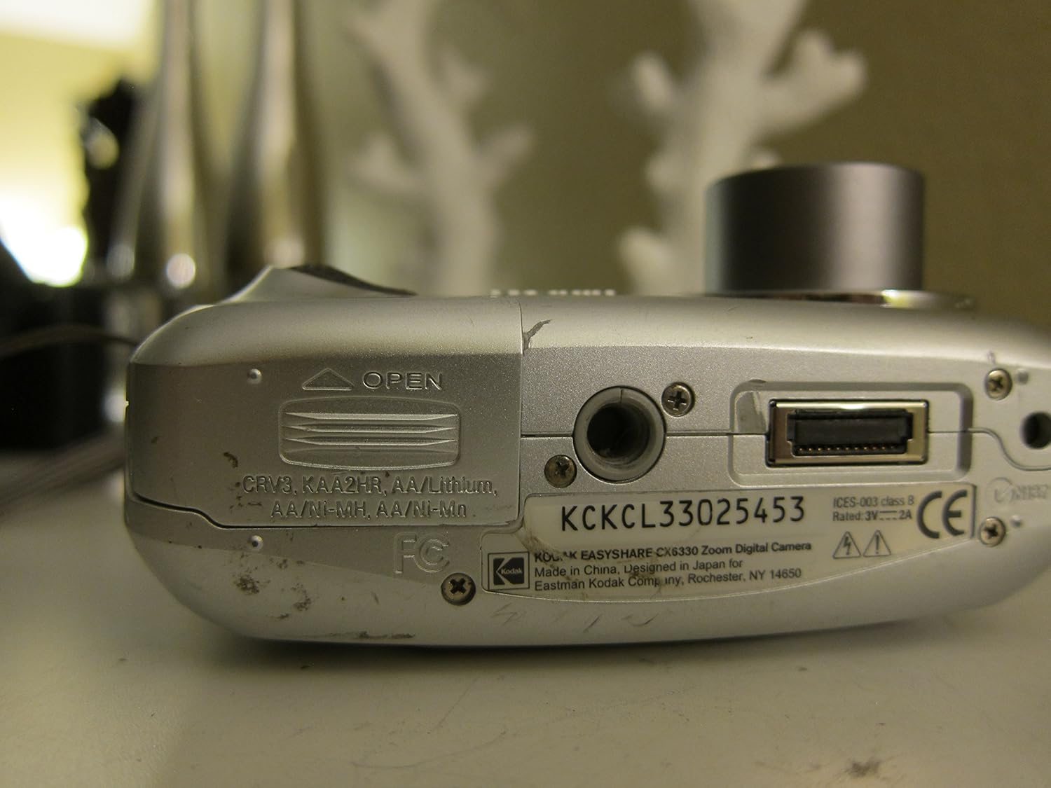 Bottom view of Kodak EasyShare CX6330 Digital Camera showing battery compartment and ports
