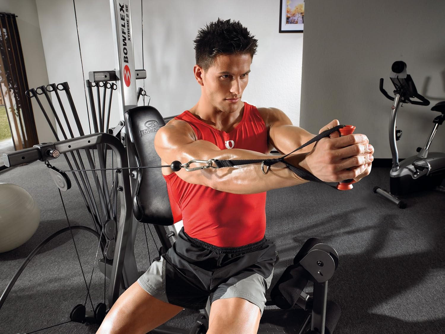 man in red tank top using bowflex xtreme 2se home gym man in red tank top using bowflex xtreme 2se home gym