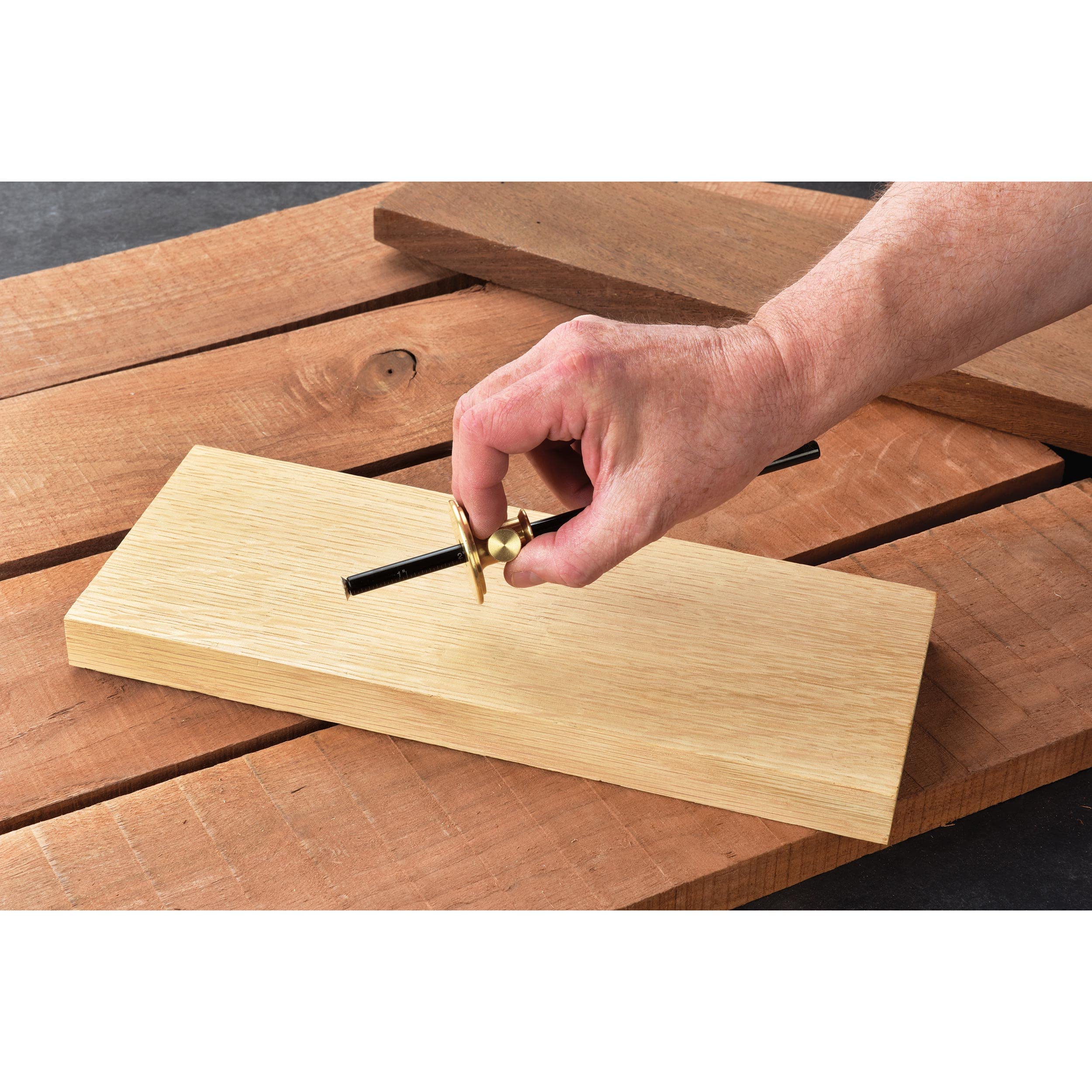 Close-up of the marking gauge scoring a line on wood