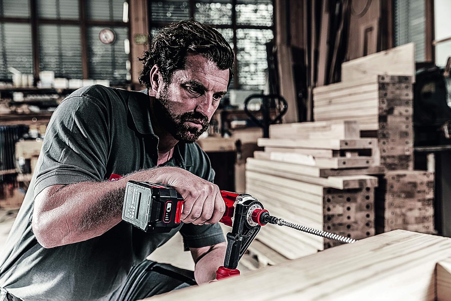 Person drilling into wood with large bit using Flex DD 4G 18.0-EC