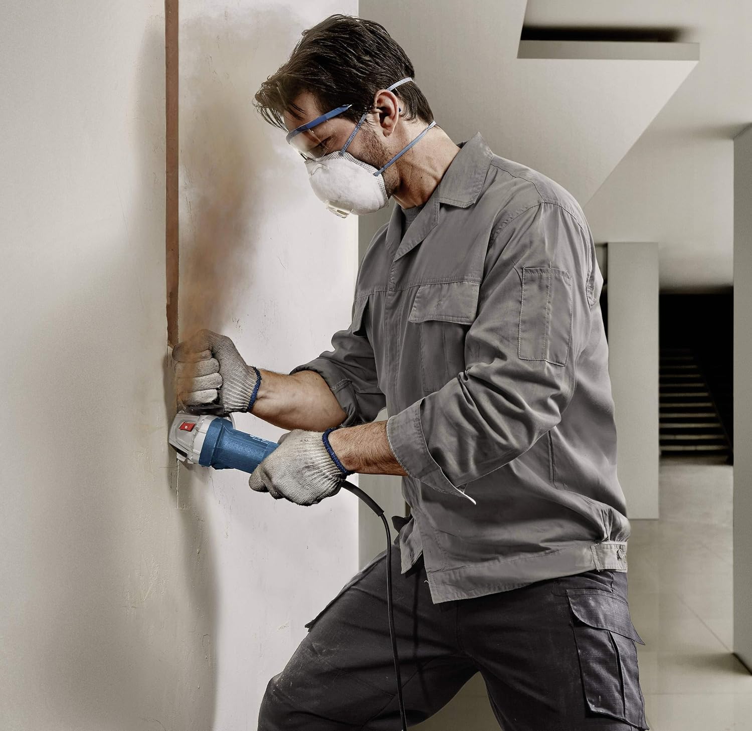 User operating Bosch Angle Grinder on a wall