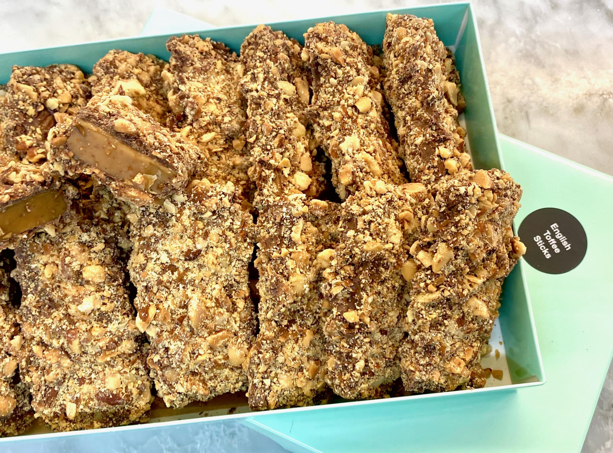 MalibuGift gourmet english toffee candy in a 1 lb fancy candy box. Sticks of gourmet english toffee doused in gourmet chocolate and rolled in roasted almonds