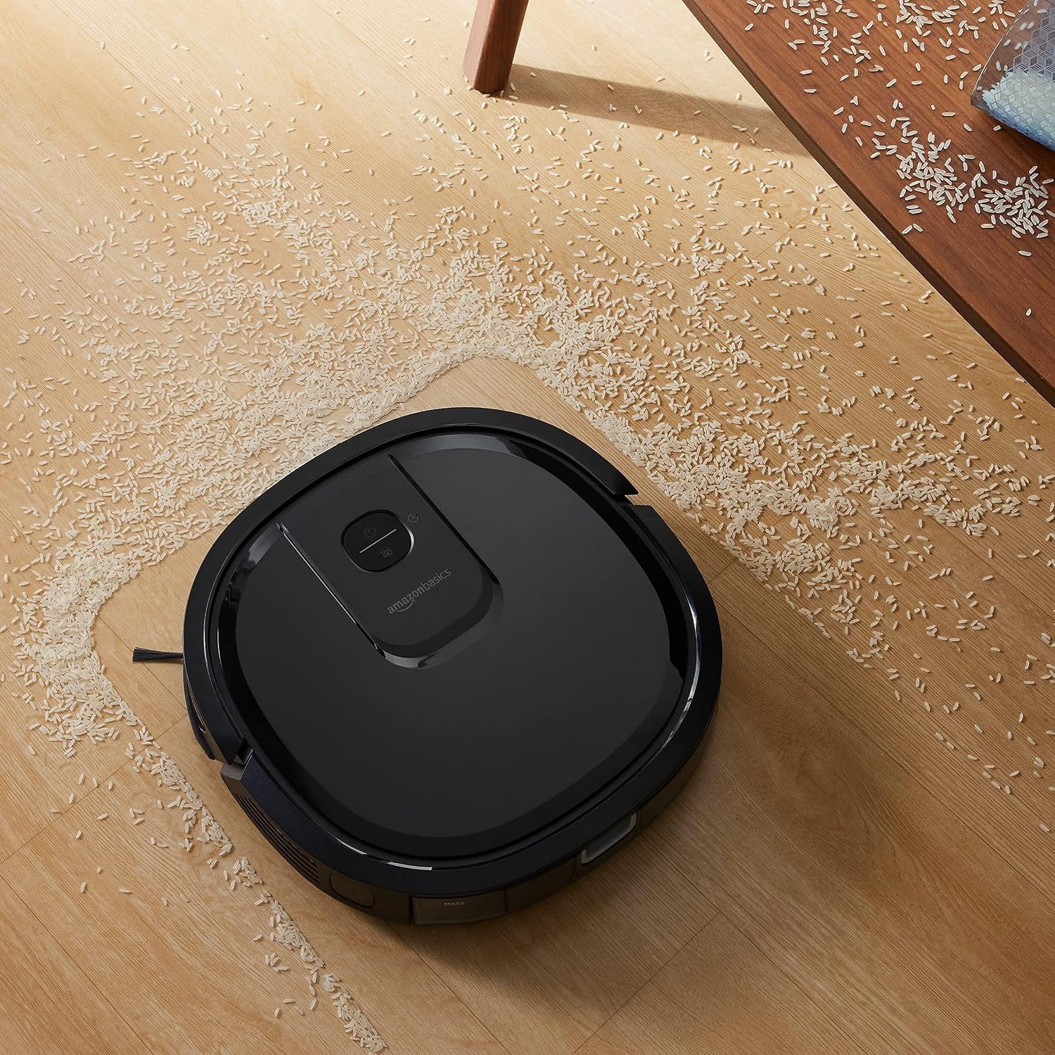 Robot vacuum cleaning a floor with scattered rice