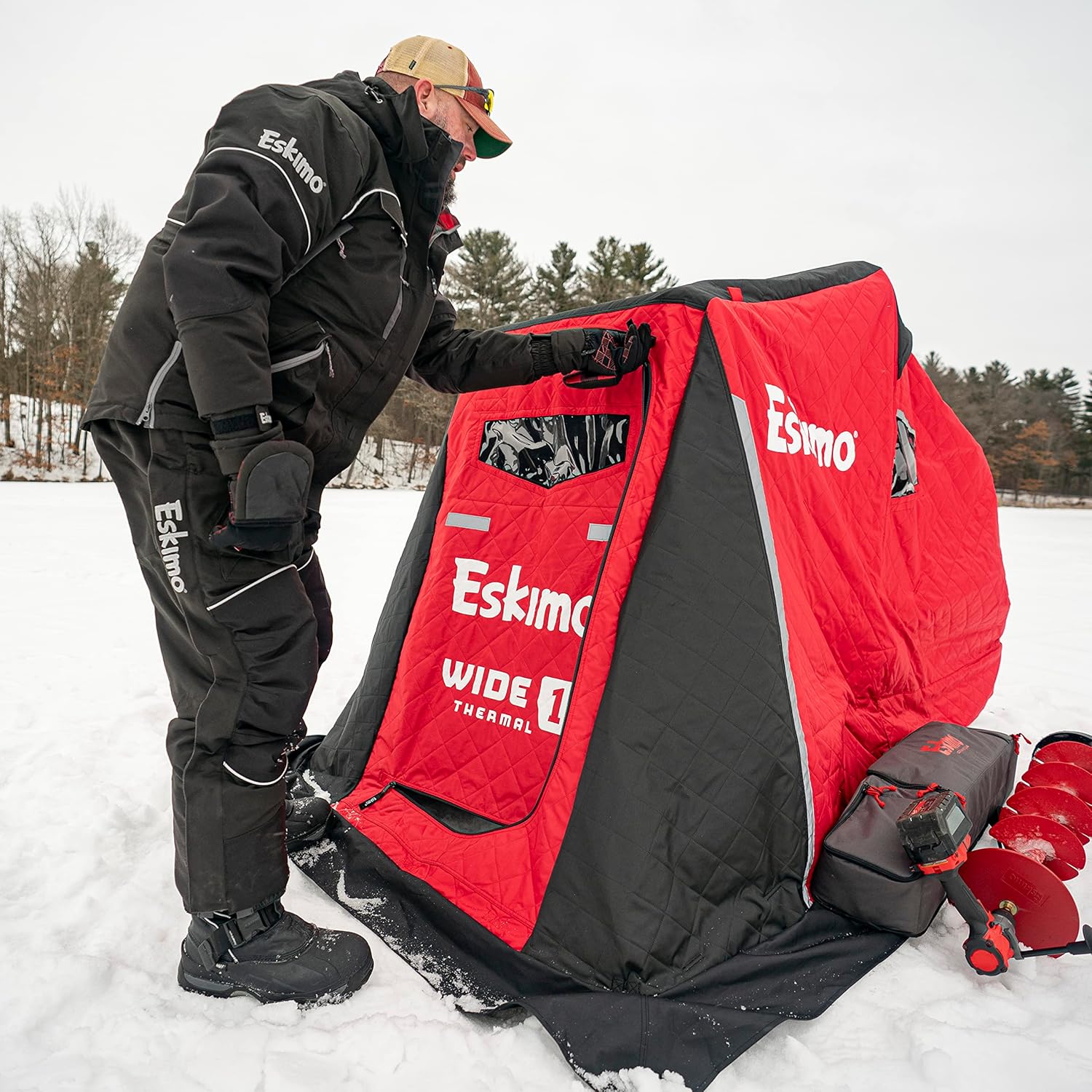 Person inspecting Eskimo Wide 1 Thermal Shelter setup