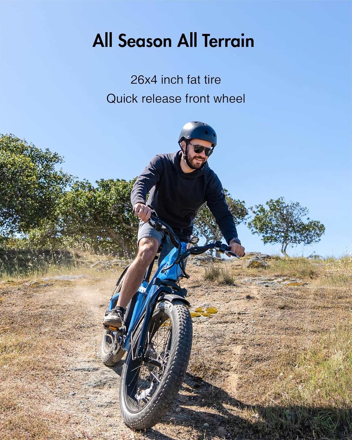 Rider on OKAI Ranger Electric Bike on a dirt trail with trees and hills