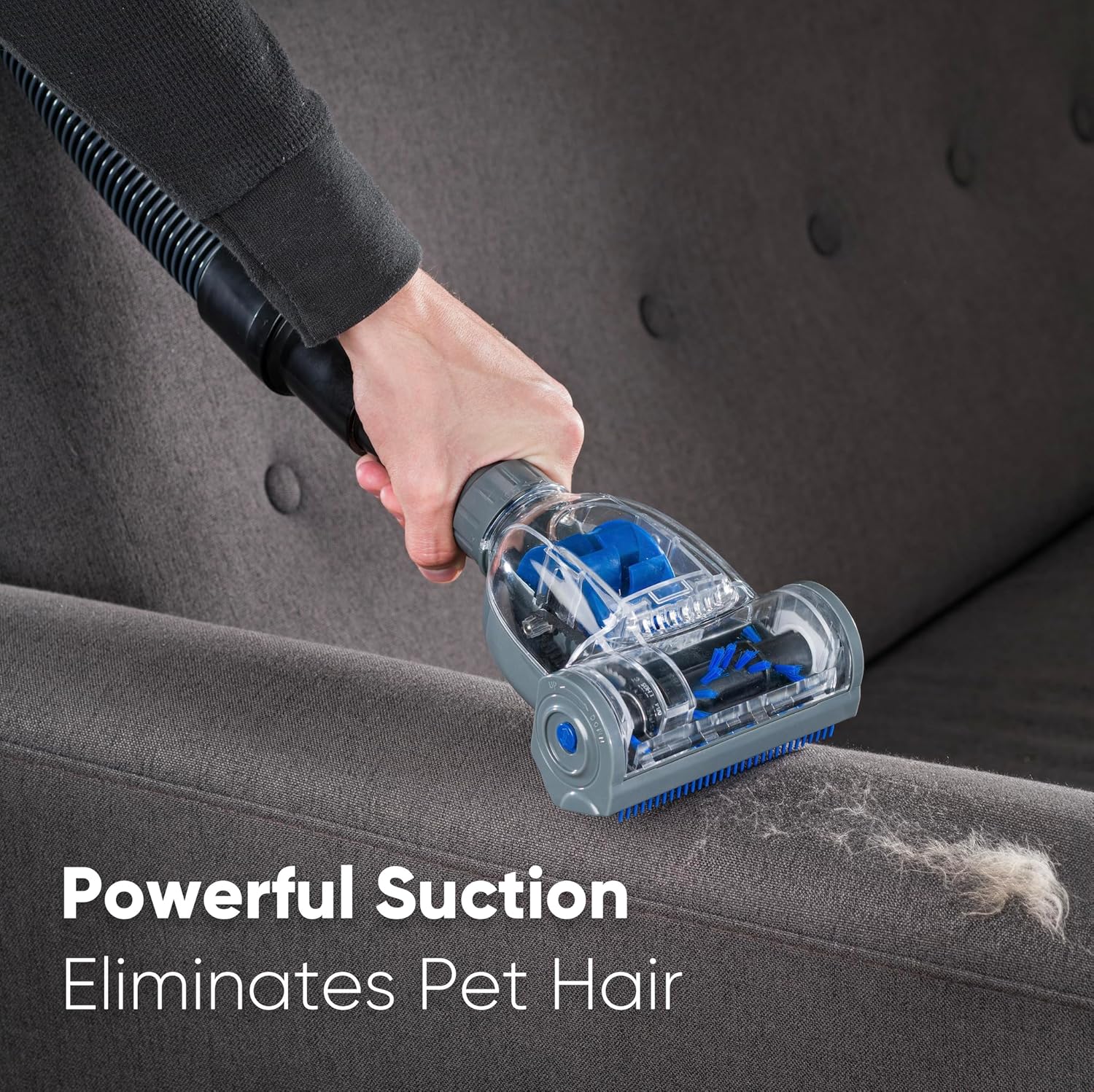 Mini Head Pet & Stair Nozzle being used to remove pet hair from a sofa.