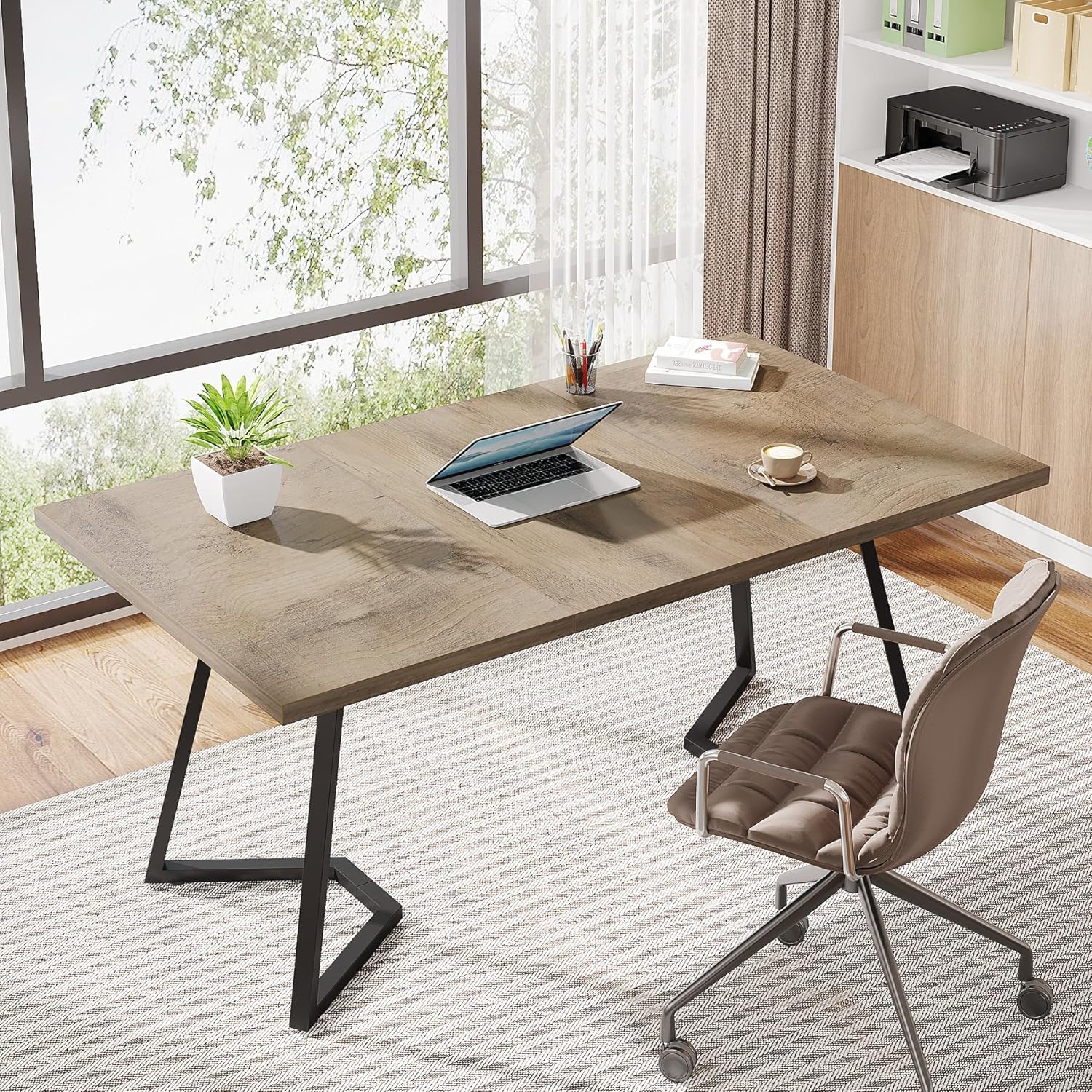 Tribesigns desk used as a computer workstation in a bright room with a large window.