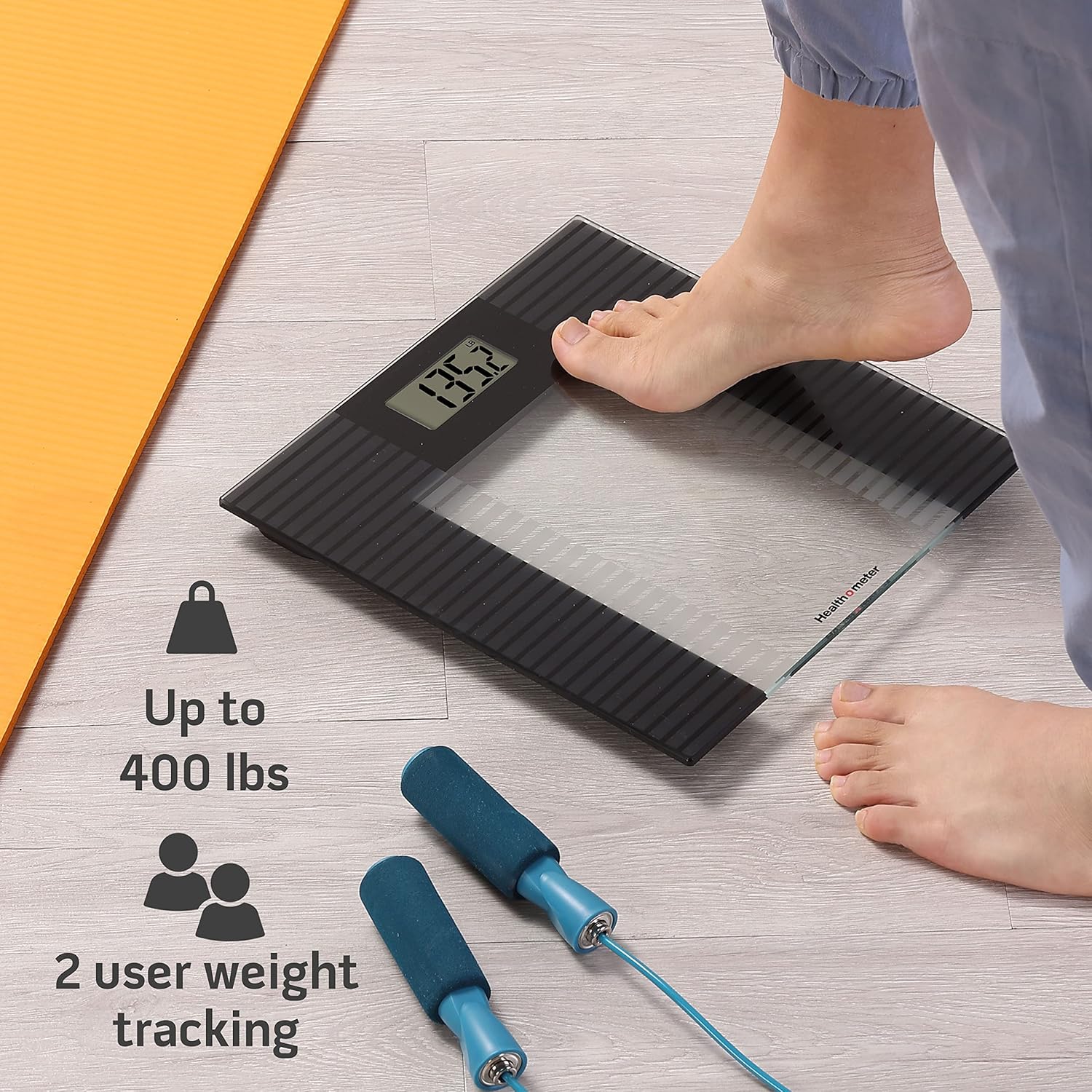 Person stepping on Health o Meter scale with icons for 400 lbs capacity and 2 user tracking