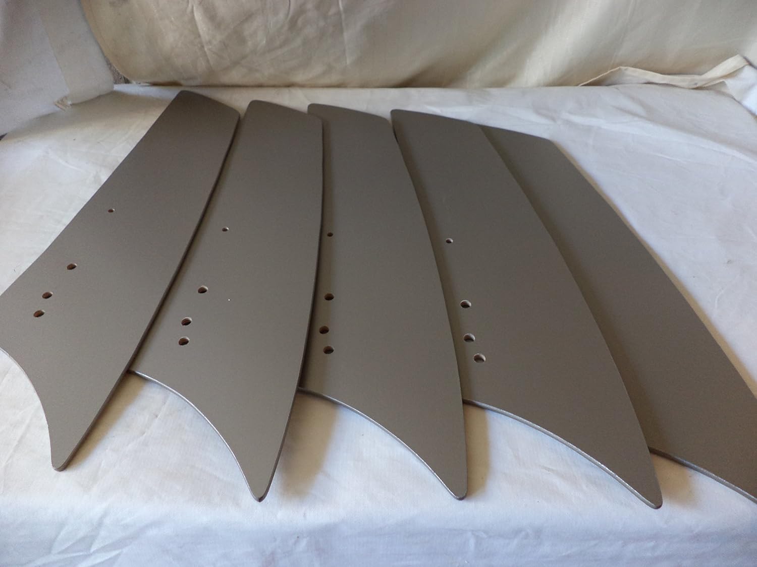 Five individual fan blades for the Hampton Bay HD285314 ceiling fan, laid out on a white surface.