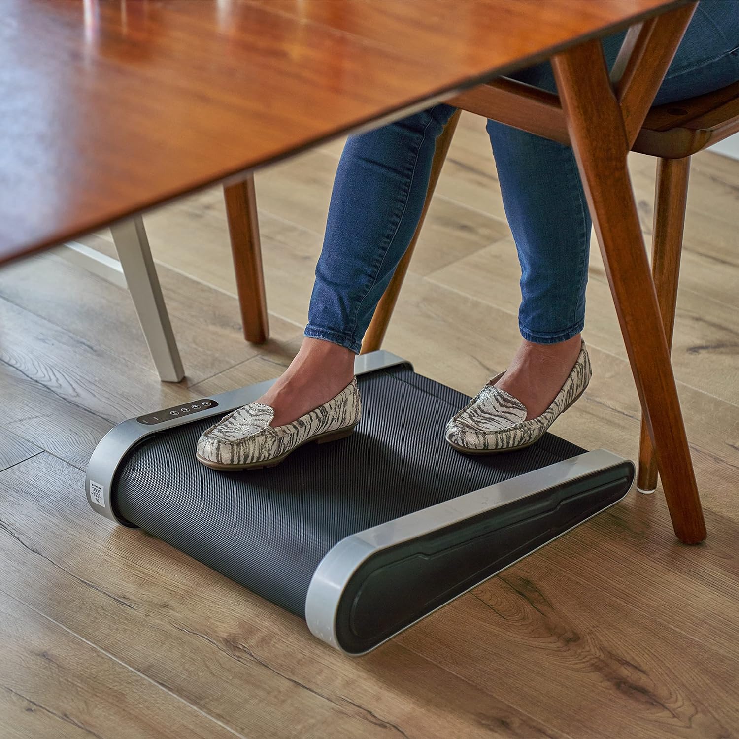 Person using Treadwell under a desk