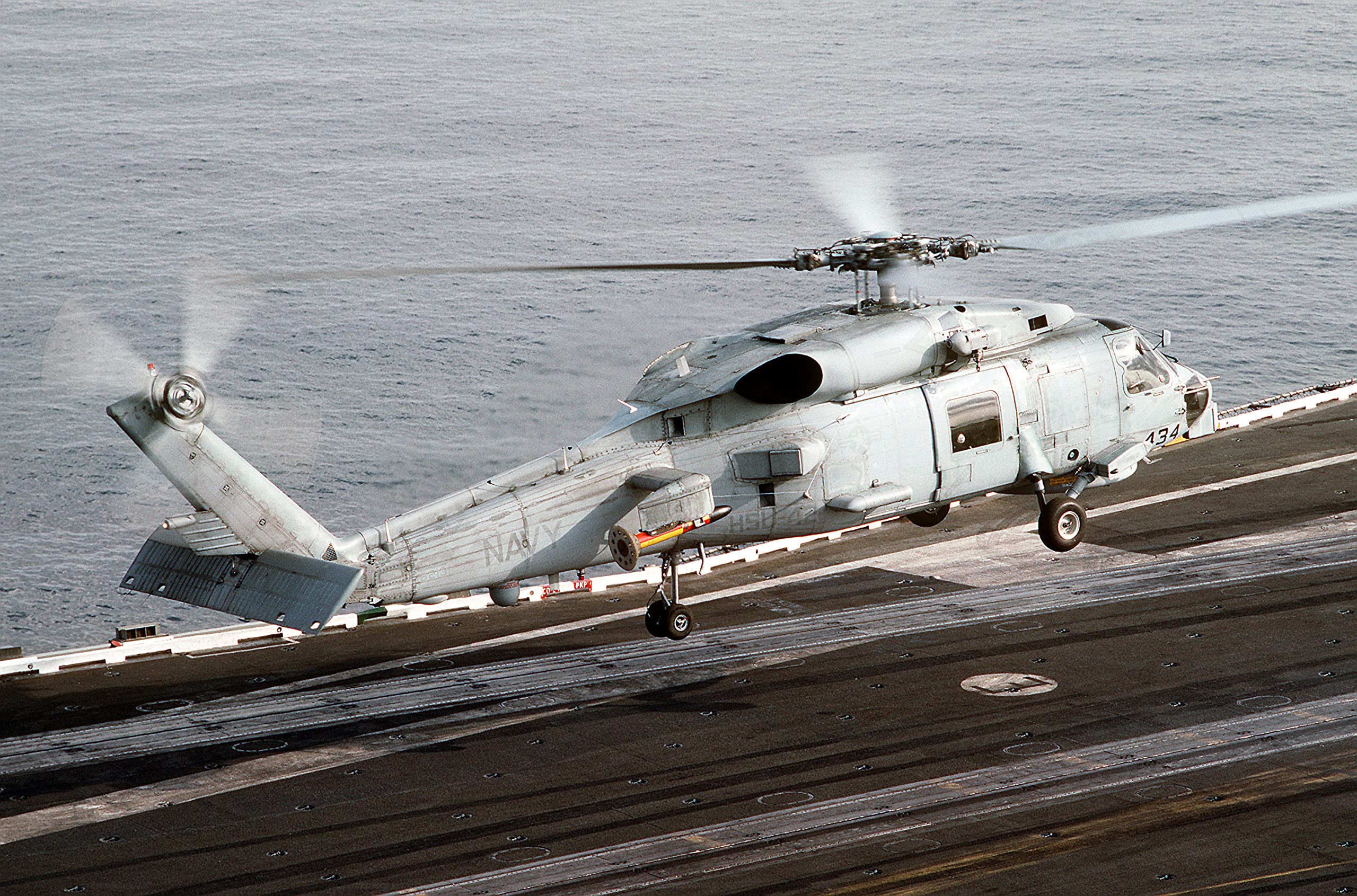 A Light Helicopter Anti-submarine Squadron 42 (HSL-42) SH-60B Sea Hawk helicopter lifts off from the flight deck of the aircraft carrier USS AMERICA (CV-66) - 20 Inch by 30 Inch Laminated Poster - Bright Colors And Vivid Imagery