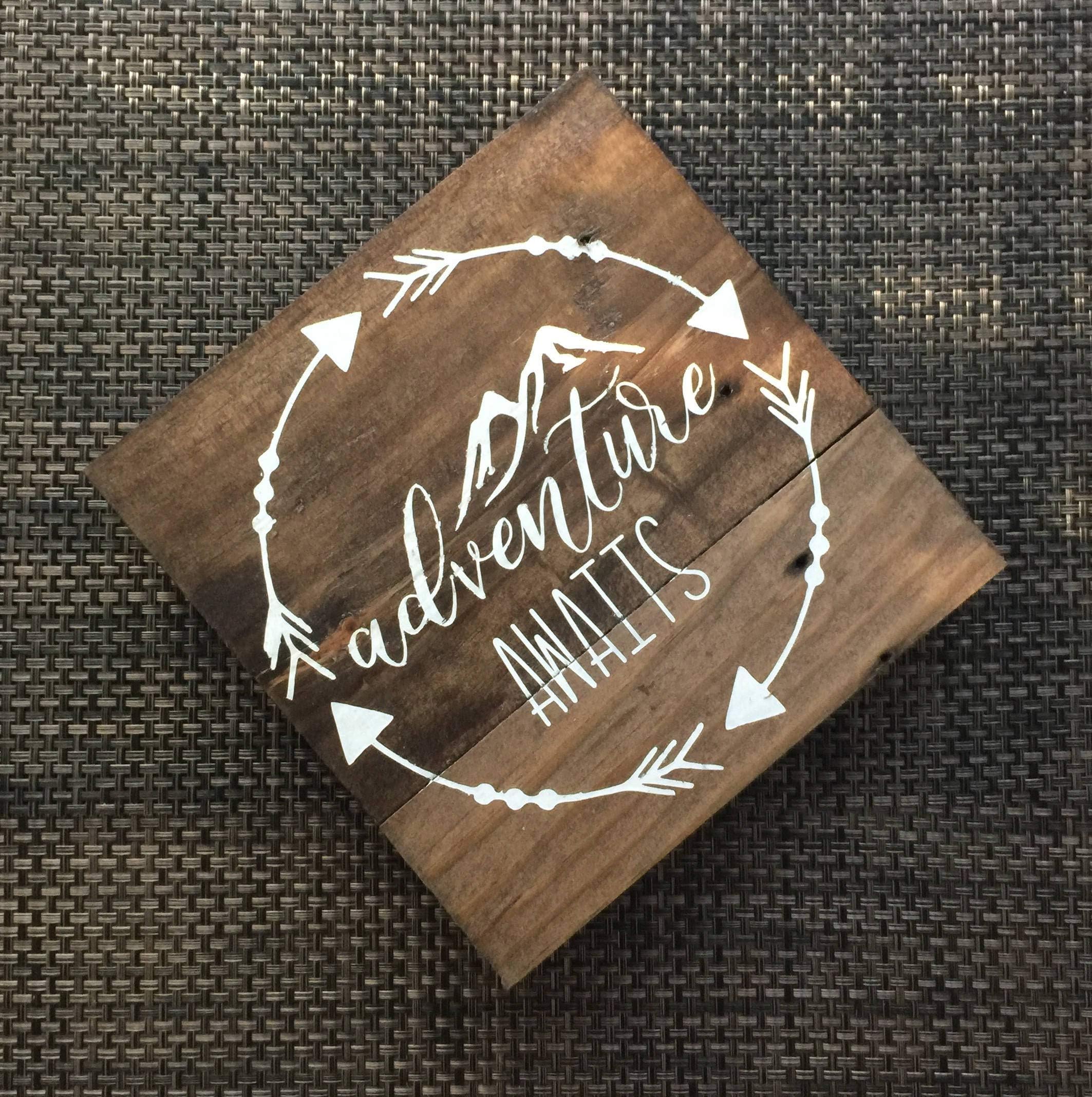 Claude16Poe Adventure awaits wood sign mountains arrows wooden sign