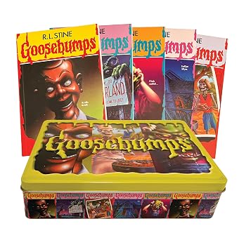 A lunch-box style tin box featuring posters of vintage Goosebumps titles sits closed. Five of the books included in the collection are spread out like a deck of cards behind it. Most prominent is the first, showing the infamous Slappy the Ventriloquist's Dummy.