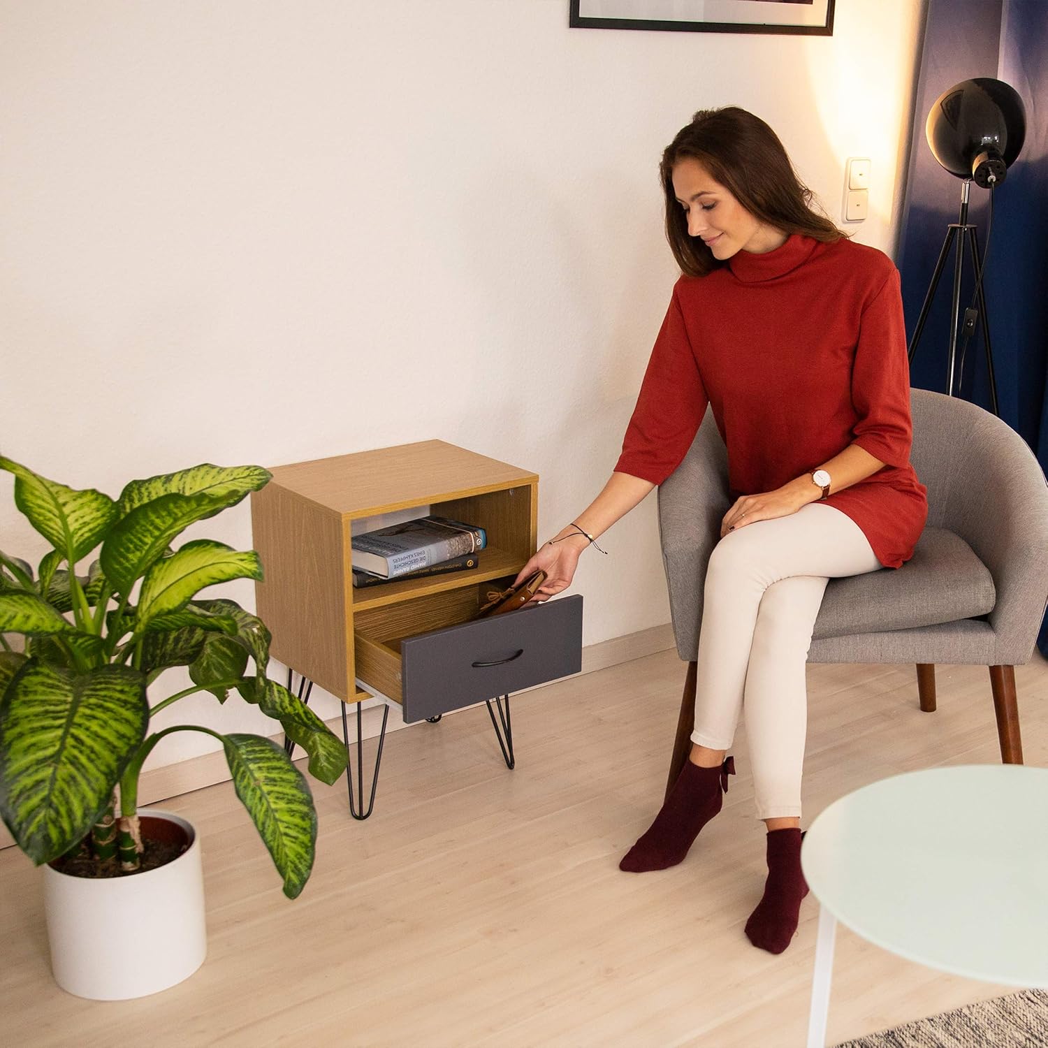 Person opening the drawer of the Relaxdays Retro Nightstand