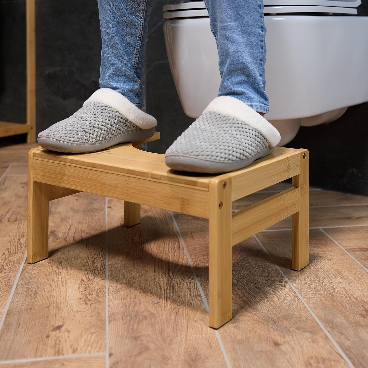 Person's feet in slippers resting on the Relaxdays Toilet Stool while seated on a toilet