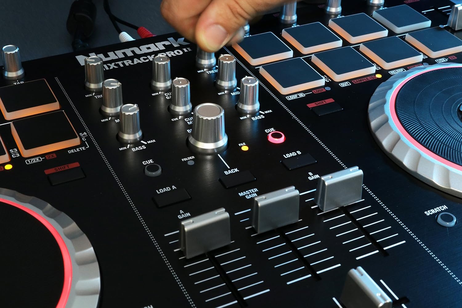 Hand adjusting Mixtrack Pro II mixer knobs