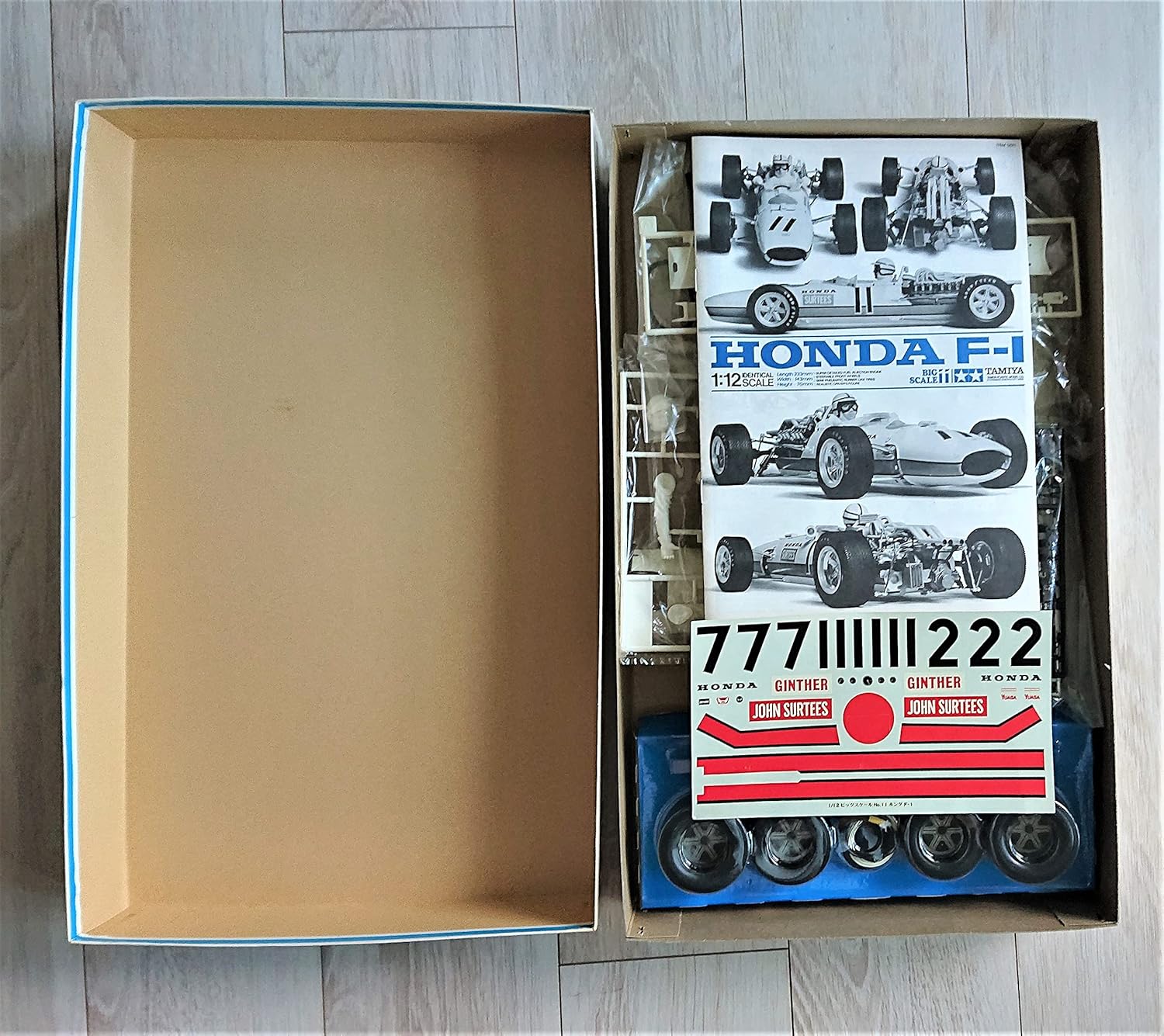 Contents of the Tamiya 1/12 Honda F-1 model kit box, showing plastic sprues, decals, and instruction sheets.