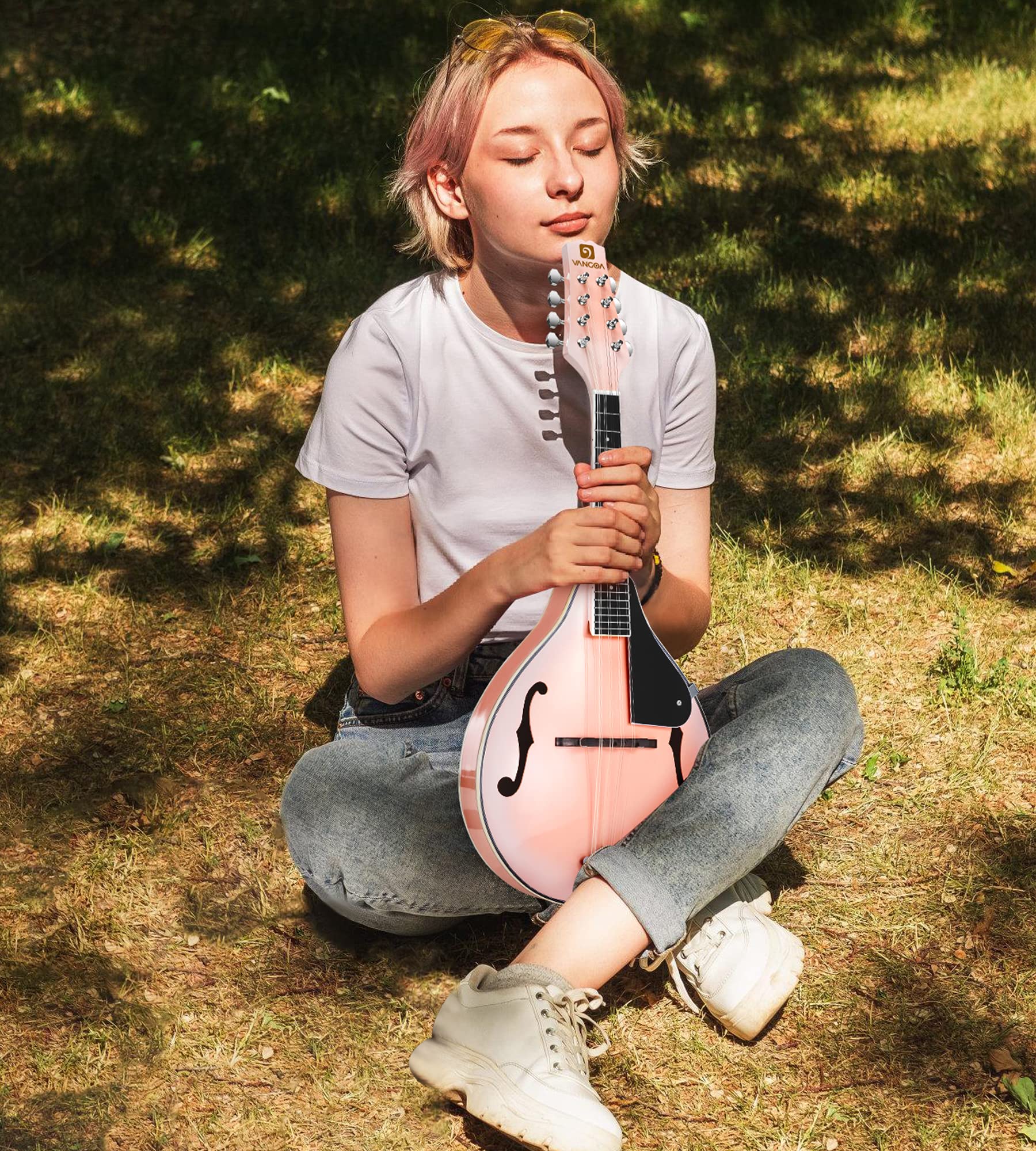 Person sitting on grass holding the Vangoa mandolin