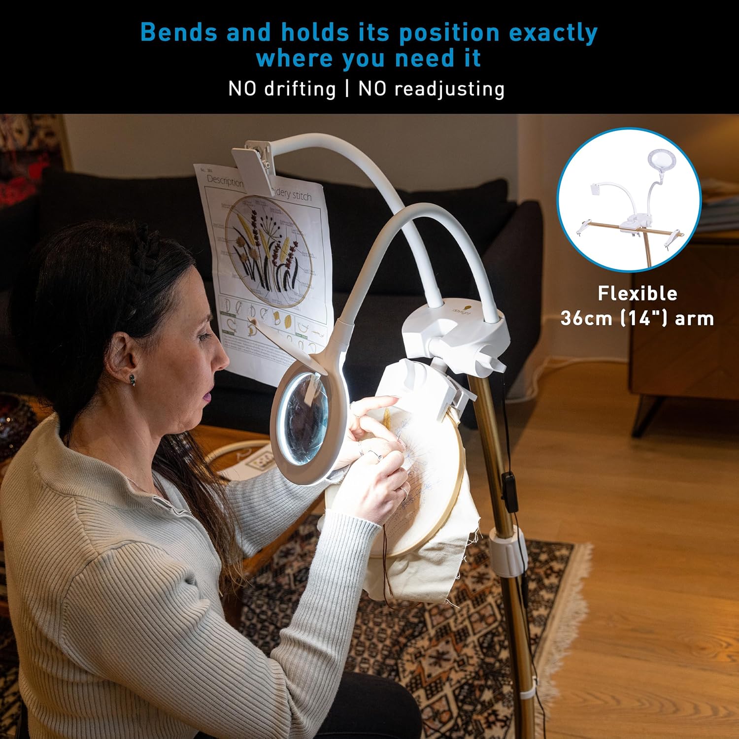 User adjusting the flexible arm of the StitchSmart 2 magnifier to position it over an embroidery project.