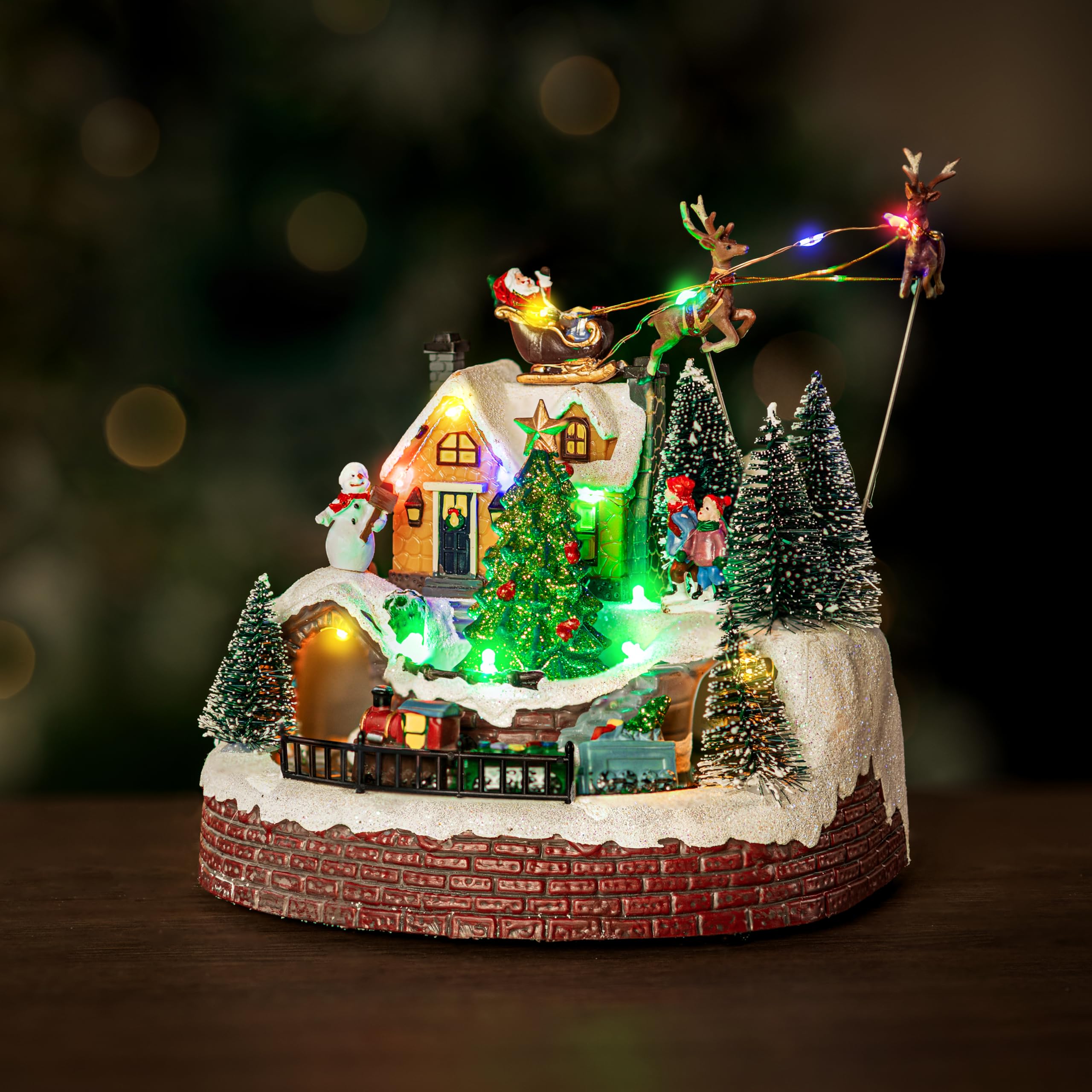 Marco Paul Christmas Decoration Musical Light Up Village Scene with Moving Train and Santa Sleigh - LED Santa & Reindeer Decoration, Polyresin Festive Ornament (Santa and Train)