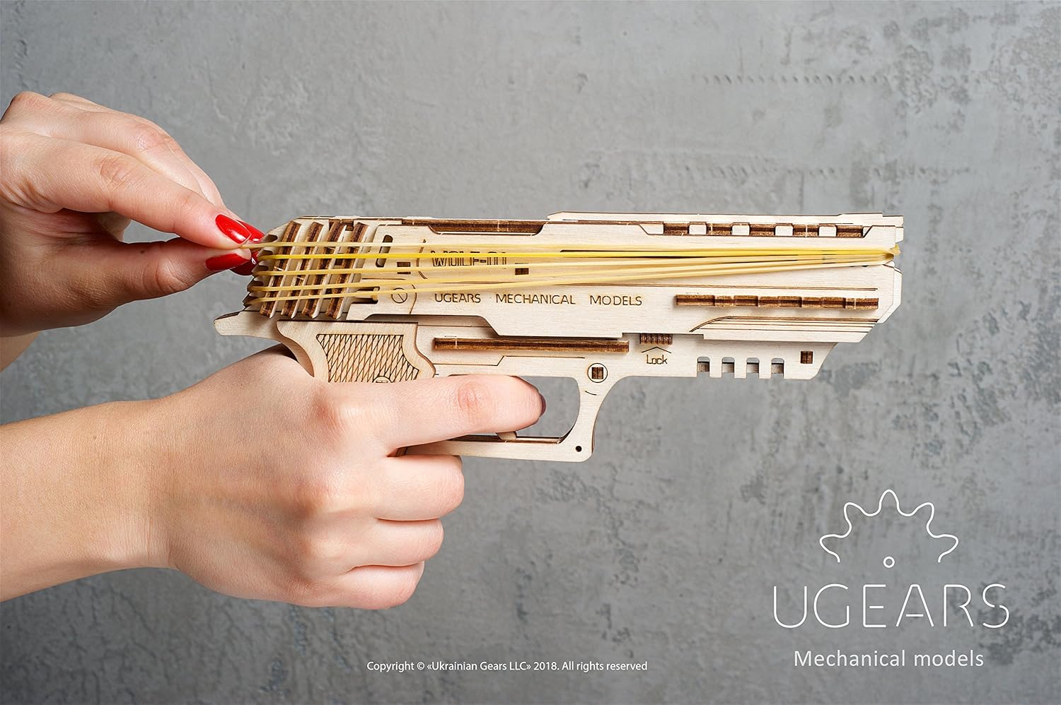 Hands holding the UGEARS Wolf-01 Handgun, aimed forward, ready to fire.