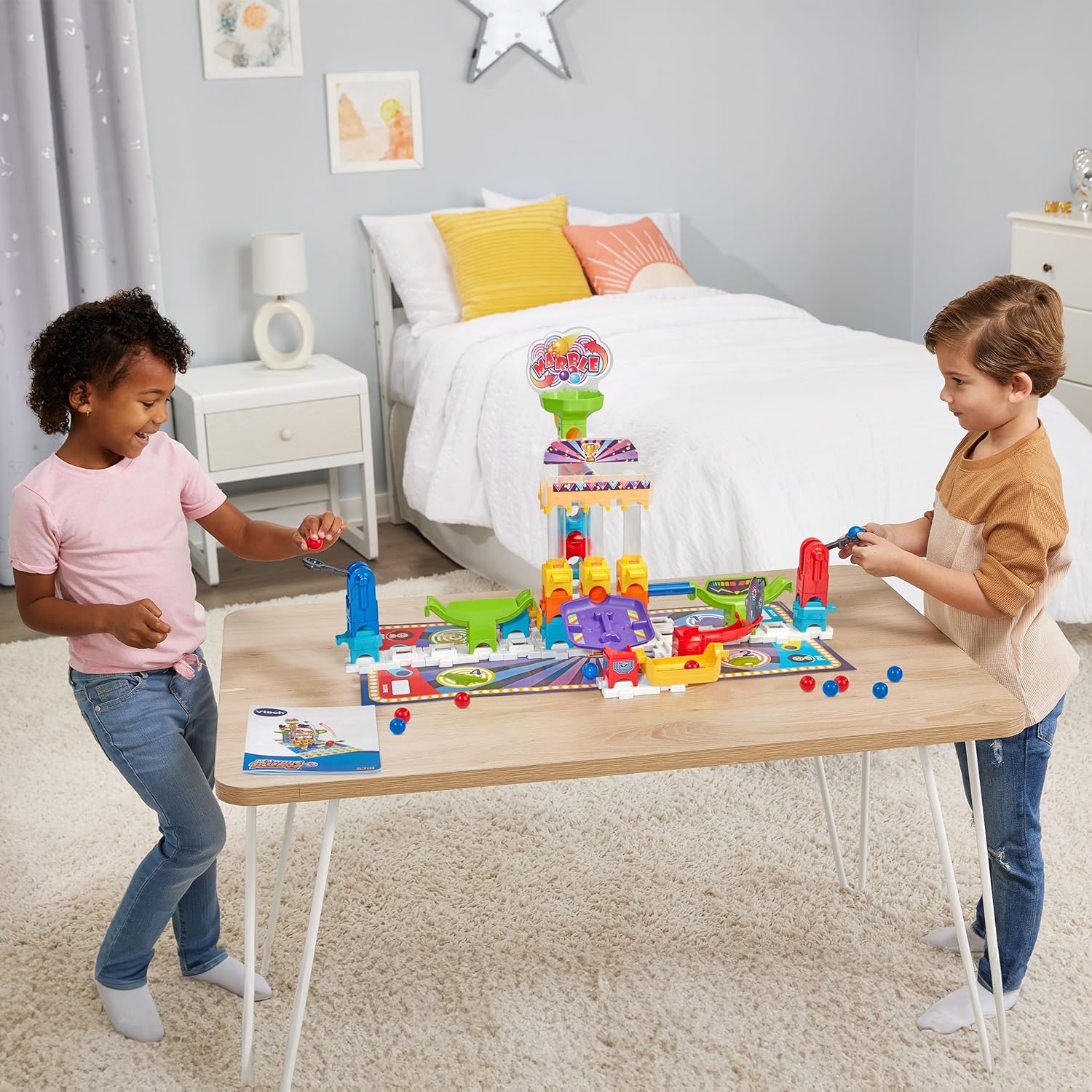 A child playing with the VTech Marble Rush S300 marble run kit on a table.