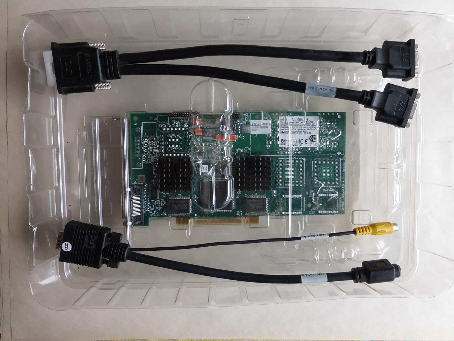 Matrox Millennium G200 Graphics Adapter and included cables in clear plastic packaging