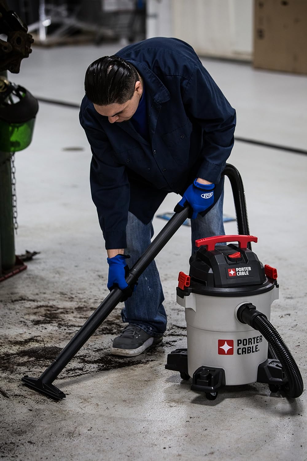 Person using the vacuum with an extension wand to reach high areas