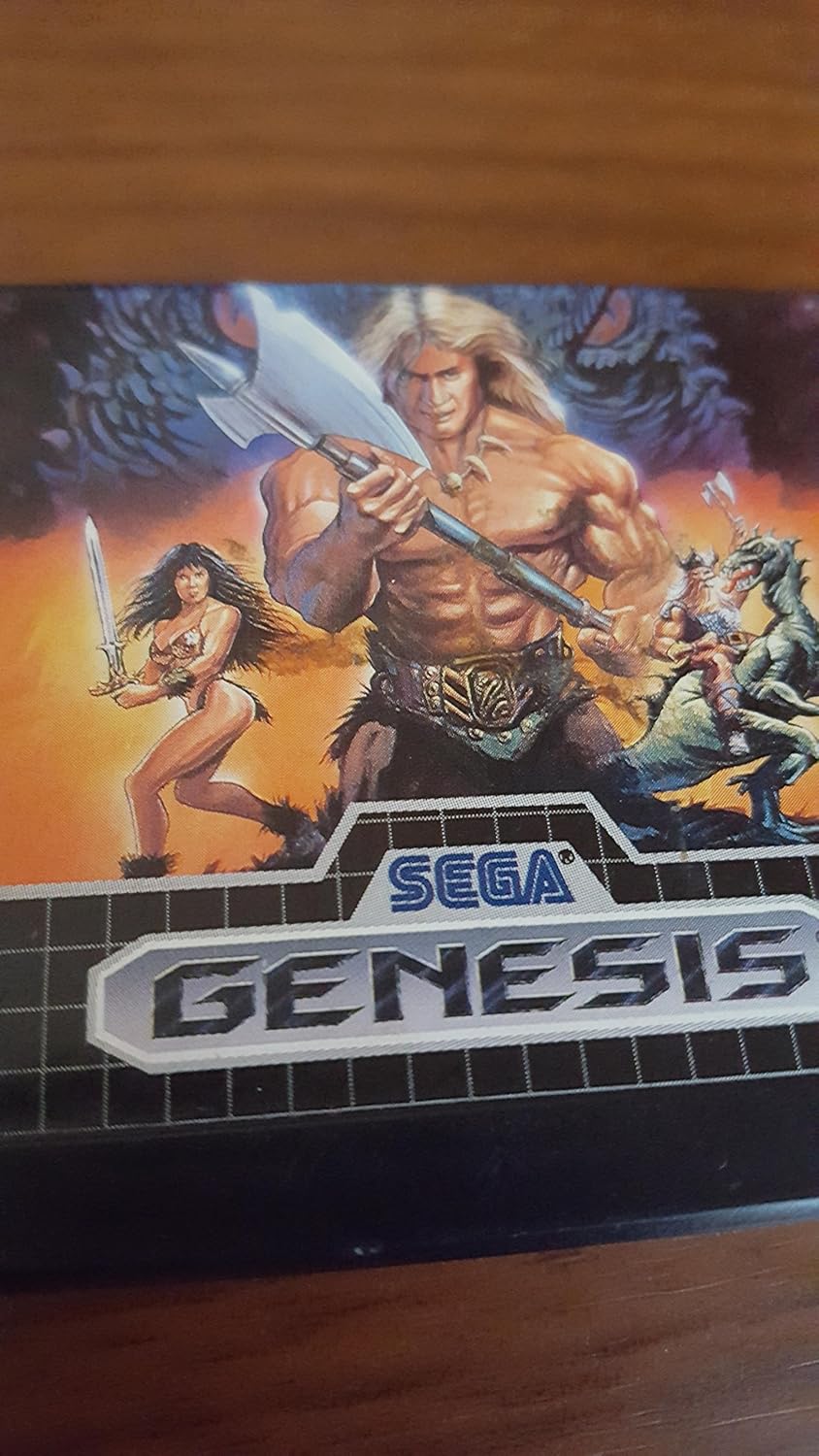 Front cover art of the Golden Axe Sega Genesis game, depicting the three main characters: Ax Battler, Tyris Flare, and Gilius Thunderhead, in a fantasy setting.