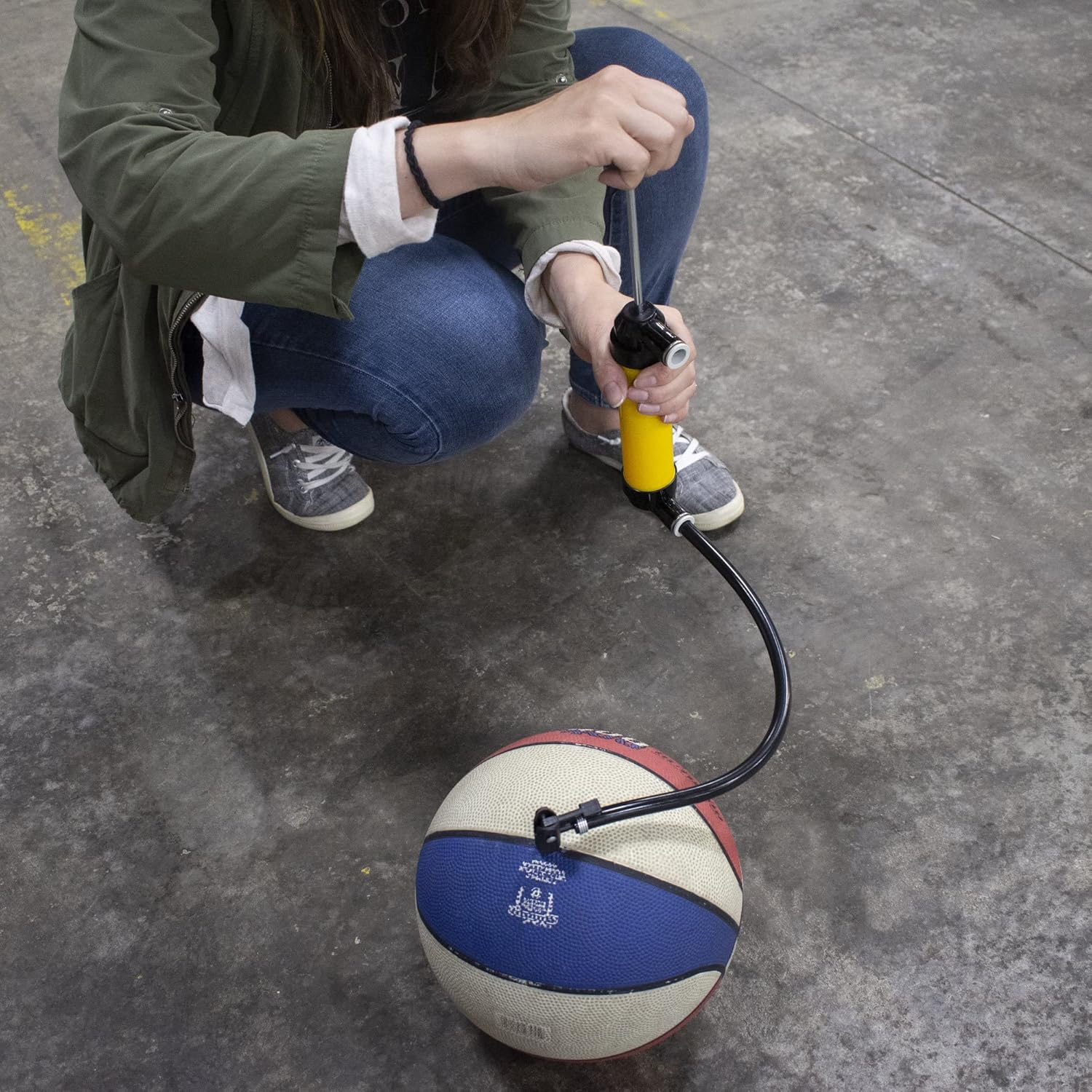 Person inflating a basketball with Hyper Tough pump