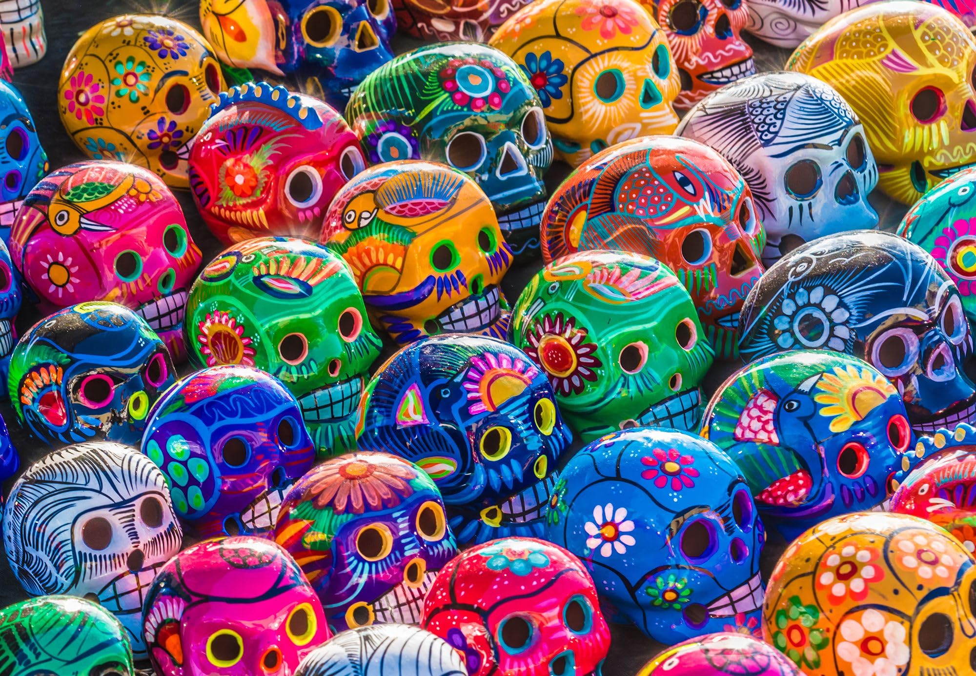 Springbok's Sugar Skulls 1000 Piece Jigsaw Puzzle for Adults is an Amazing Colorful Display of Painted Skulls or Calaveras - Traditional Mexican Folk Art.