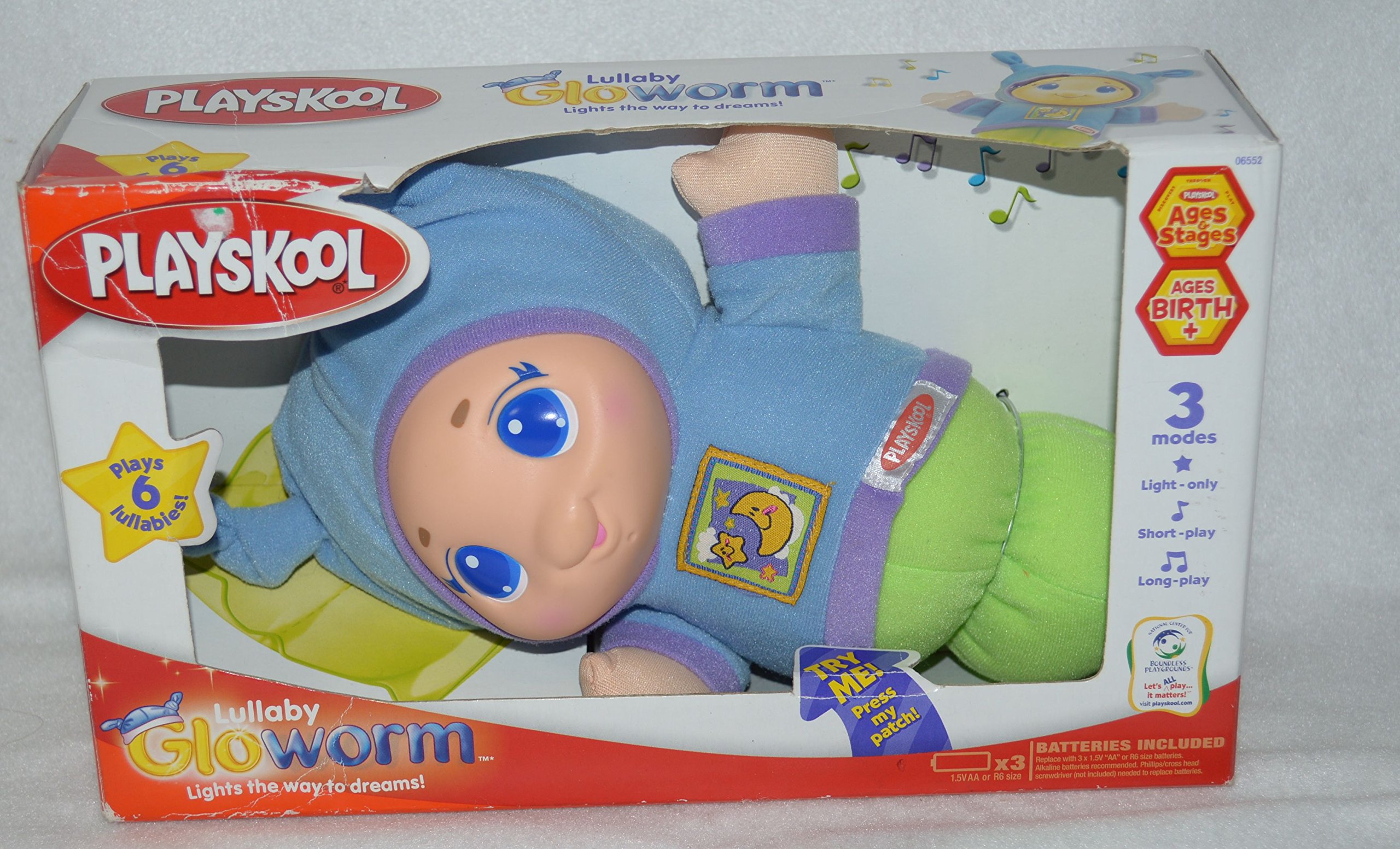 Hasbro Playskool Lullaby Gloworm in its packaging, showing its friendly glowing face, purple nightshirt with moon and star, and features like 'Plays 6 soothing lullabies' and 'Easy to squeeze'.