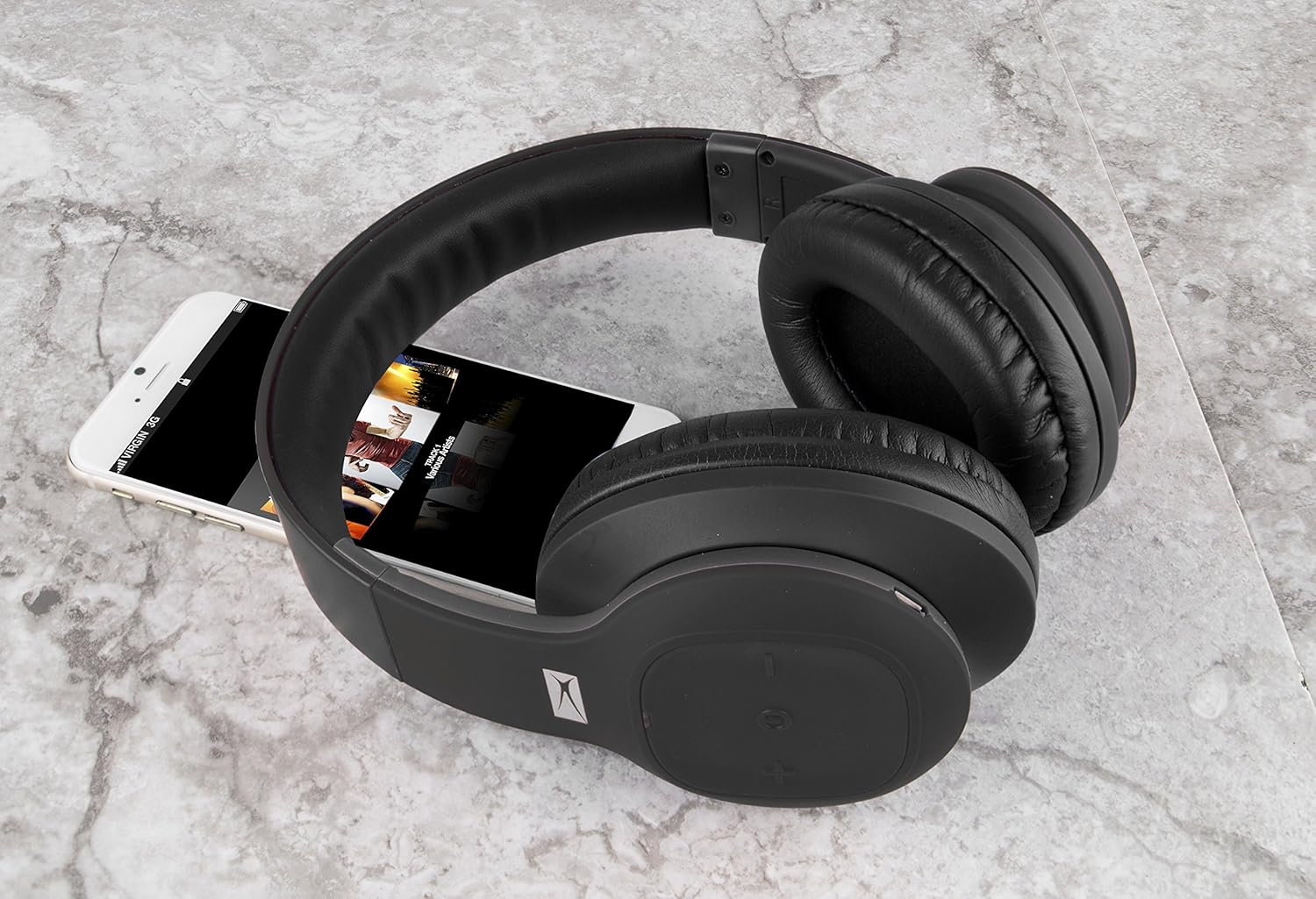 Altec Lansing MZX300-BLK Headphones next to a smartphone