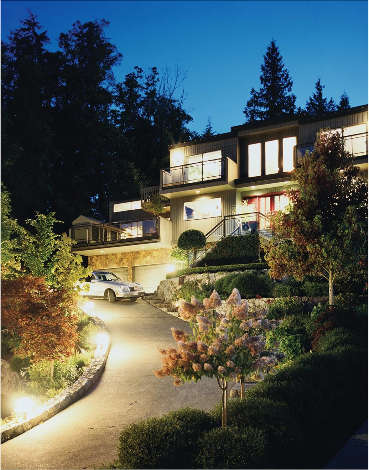 Outdoor flood lights illuminating a house and driveway