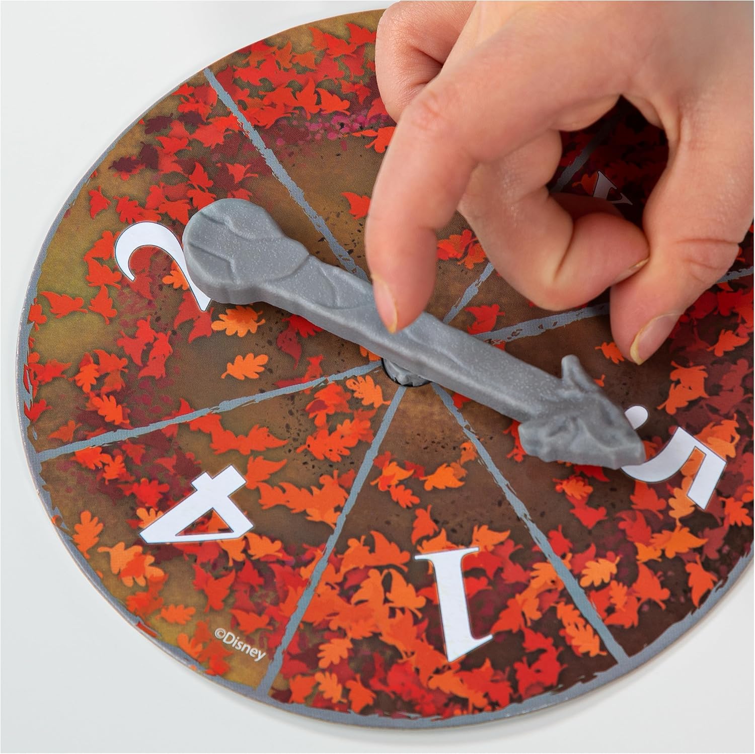 Game spinner with numbers 1-4 and autumn leaf design