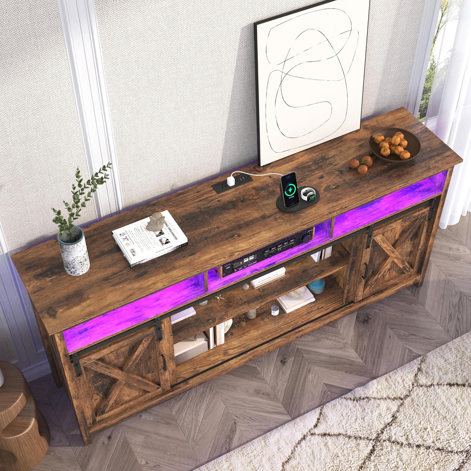 Top view of the TV stand showing the built-in power outlet with USB ports and a wireless charging pad.