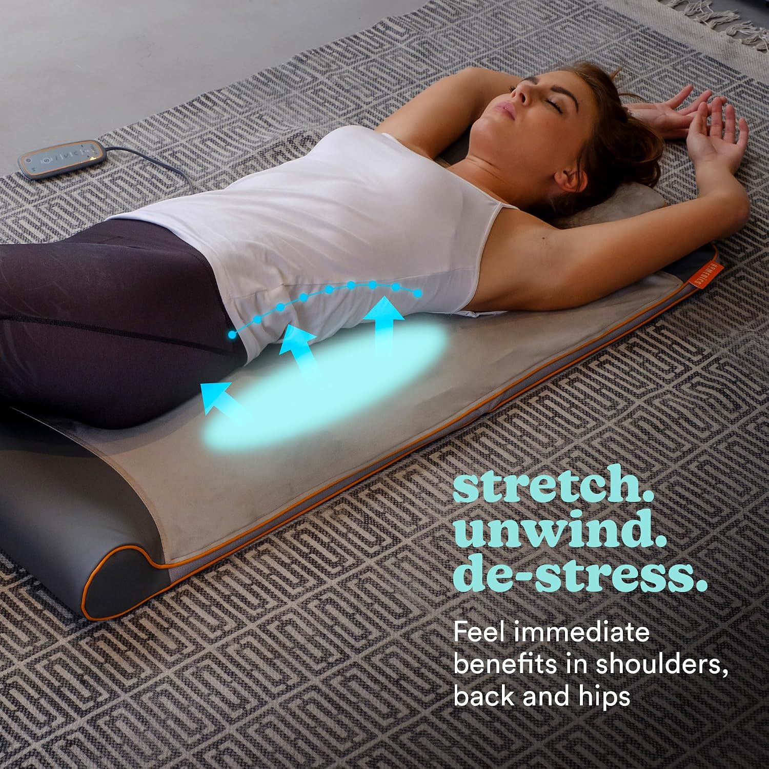 Woman on HoMedics Stretch Mat showing lower back stretch
